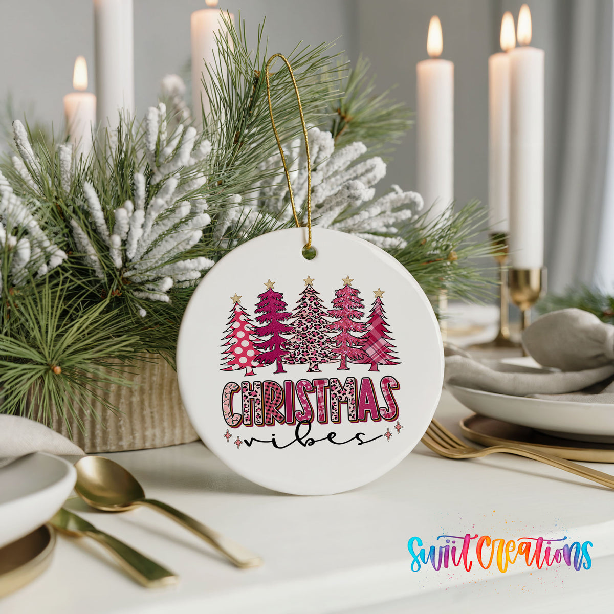 A white Christmas ornament with a leopard print design and the text "Christmas vibes" hangs on a table, surrounded by a floral arrangement and candles.