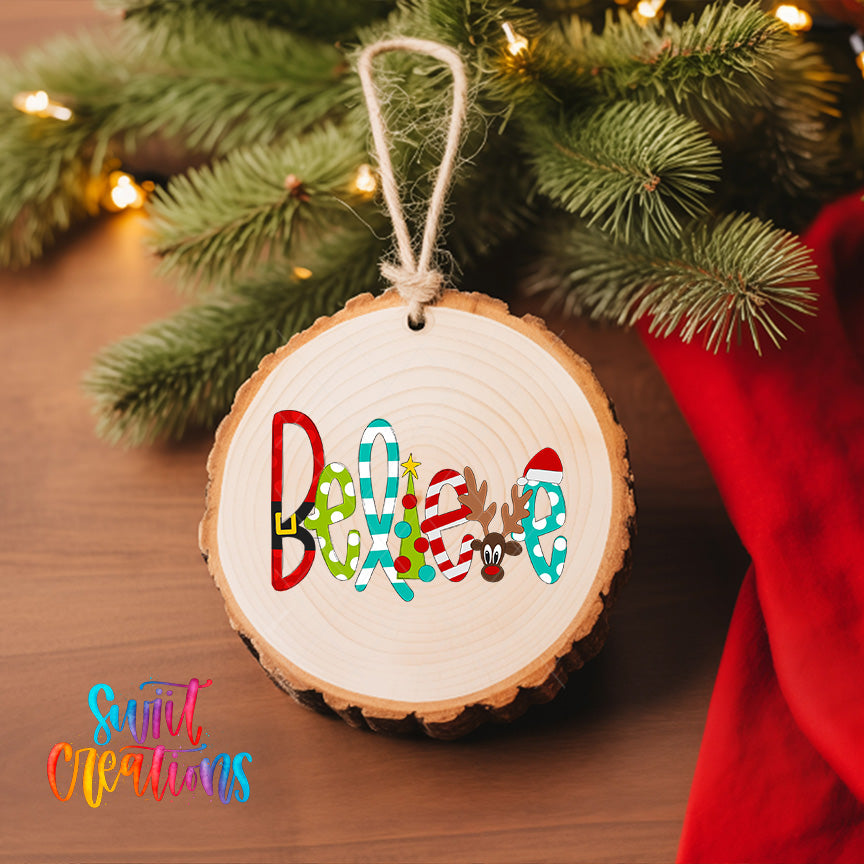 A wooden ornament with the word "Believer" written on it, hanging on a Christmas tree.