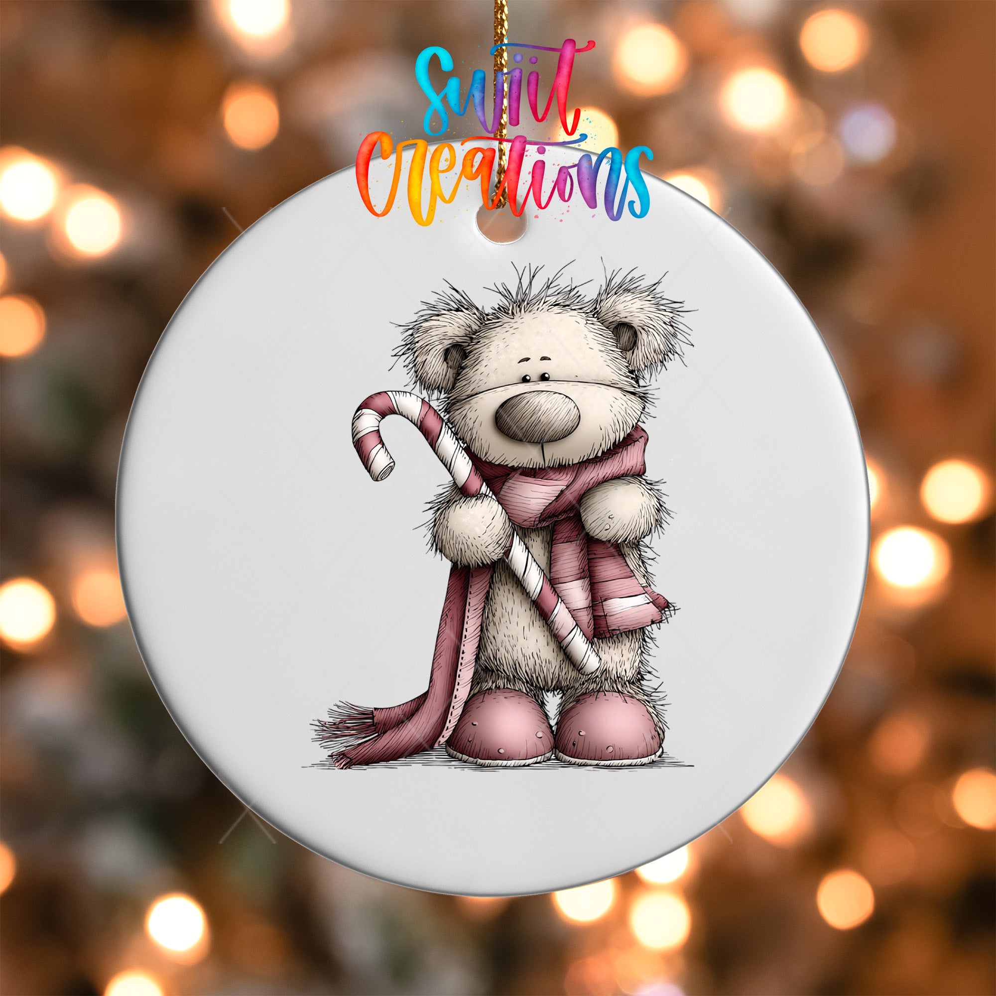 A white ornament with a cartoon illustration of a teddy bear holding a candy cane.