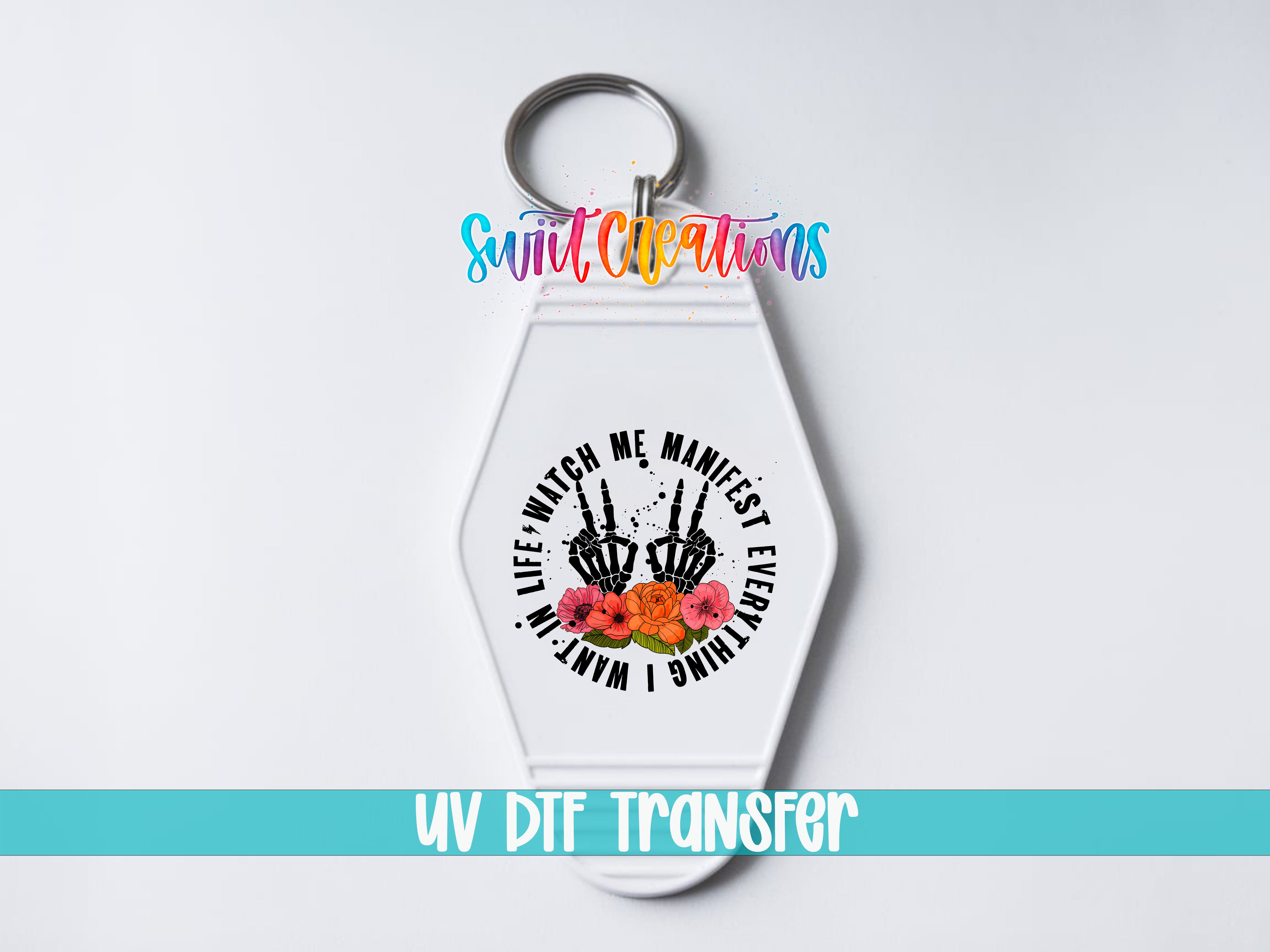 A white keychain with a colorful design and text on it.