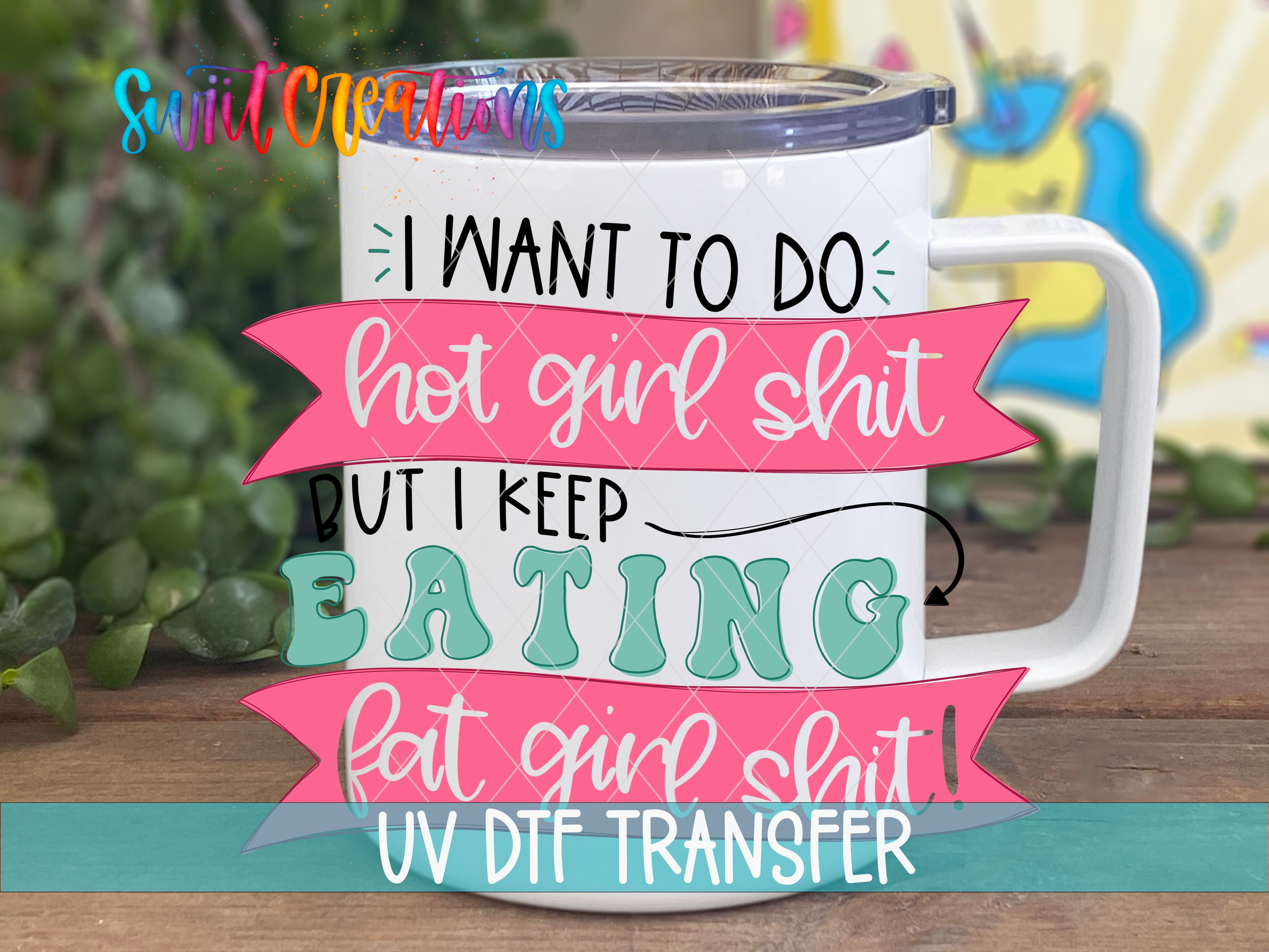 A white mug with colorful text and graphics on it, placed on a wooden surface.