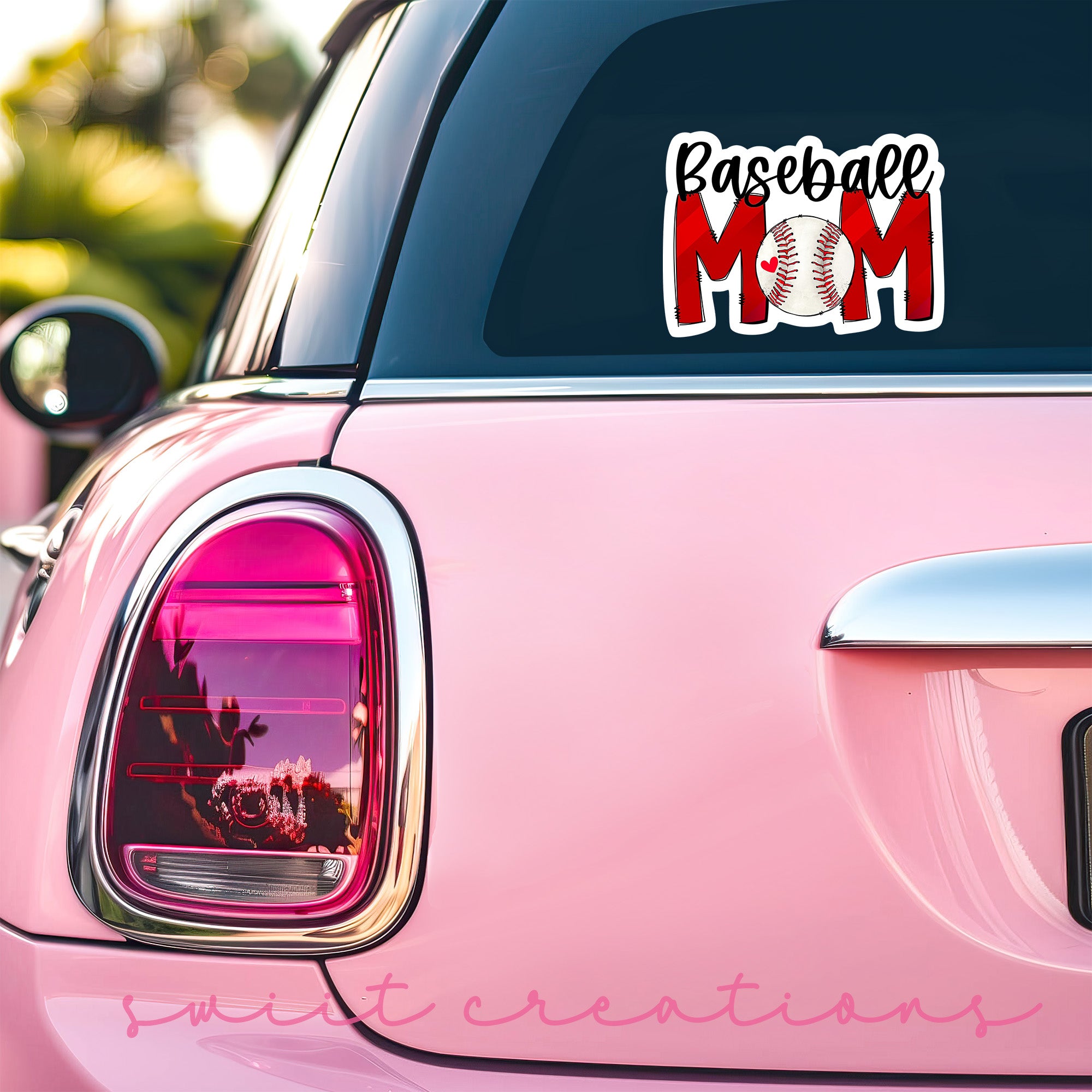 a pink car with a baseball mom sticker on it