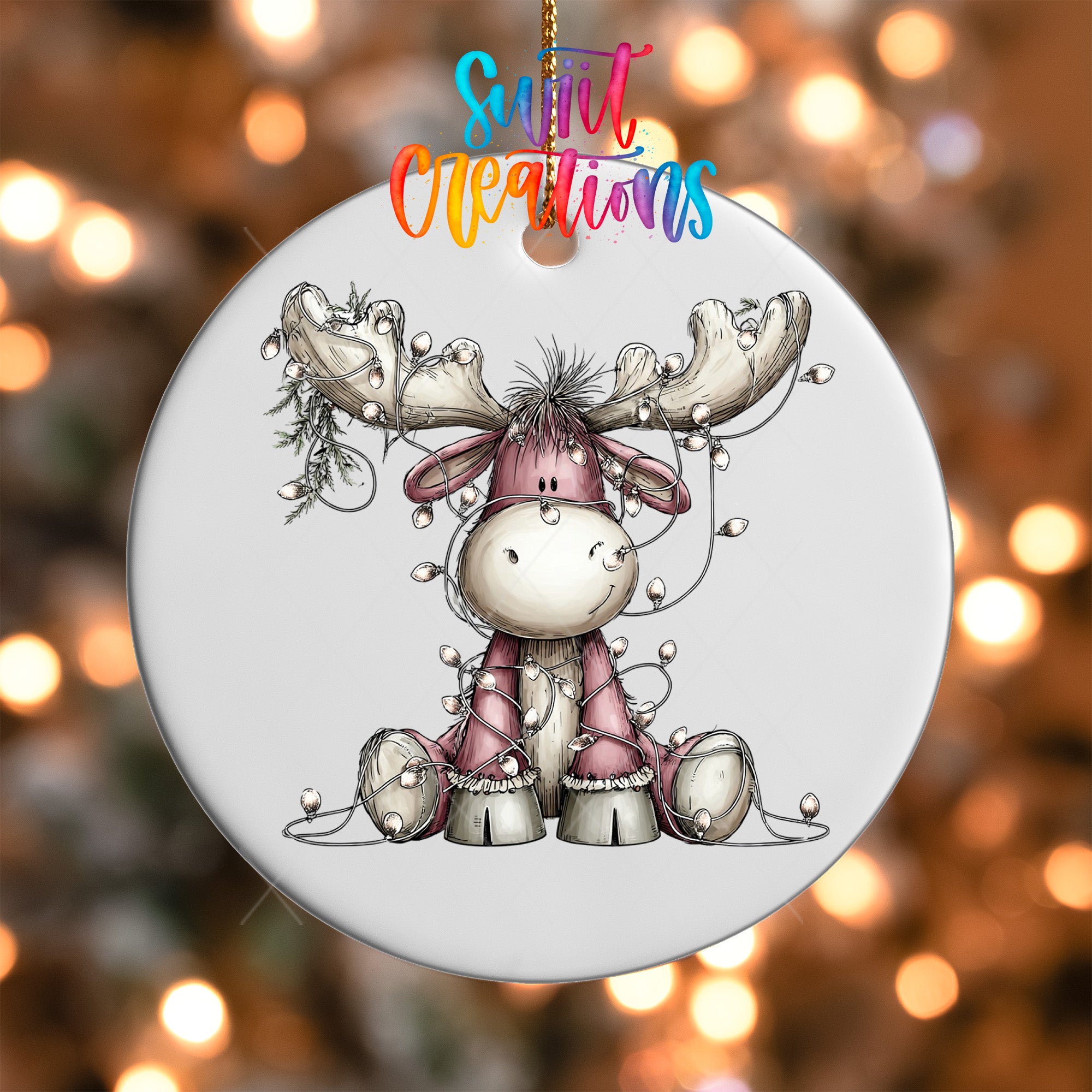 A white ornament with a cartoon moose and Christmas lights.