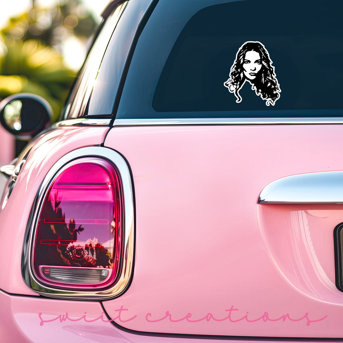 a pink car with a sticker of a woman's face