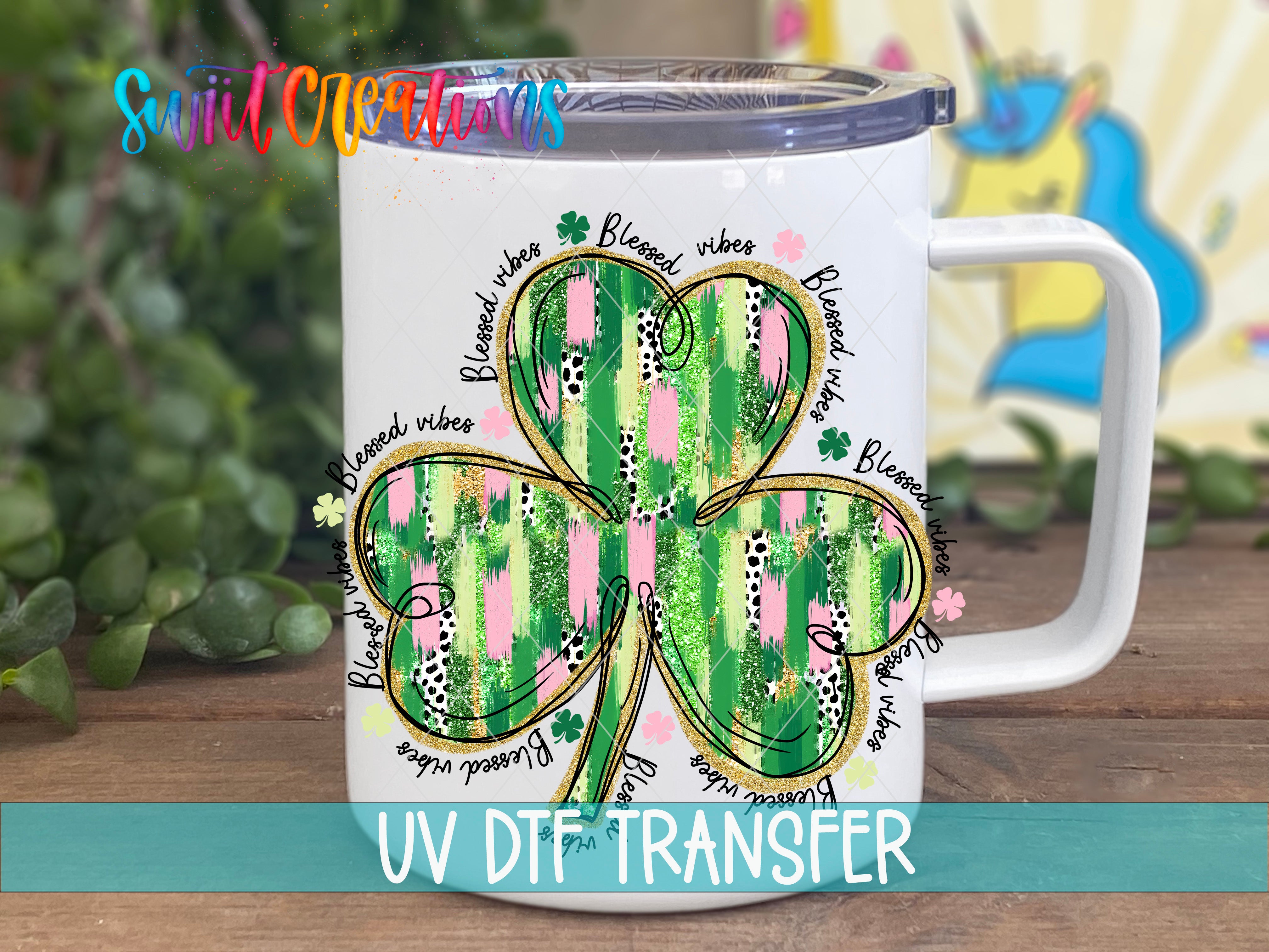 a white coffee mug with a four leaf clover on it