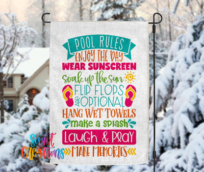 A colorful sign with text that reads "POOL RULES ENJOY THE DAY WEAR SUNSCREEN SCOAK UP THE SUN FLIP FLOPS AND OPTIONAL HANG WET TOWELS MAKE A SPASH LAUGH & PLAY MAKE MEMORIES" is displayed in front of a snowy background.
