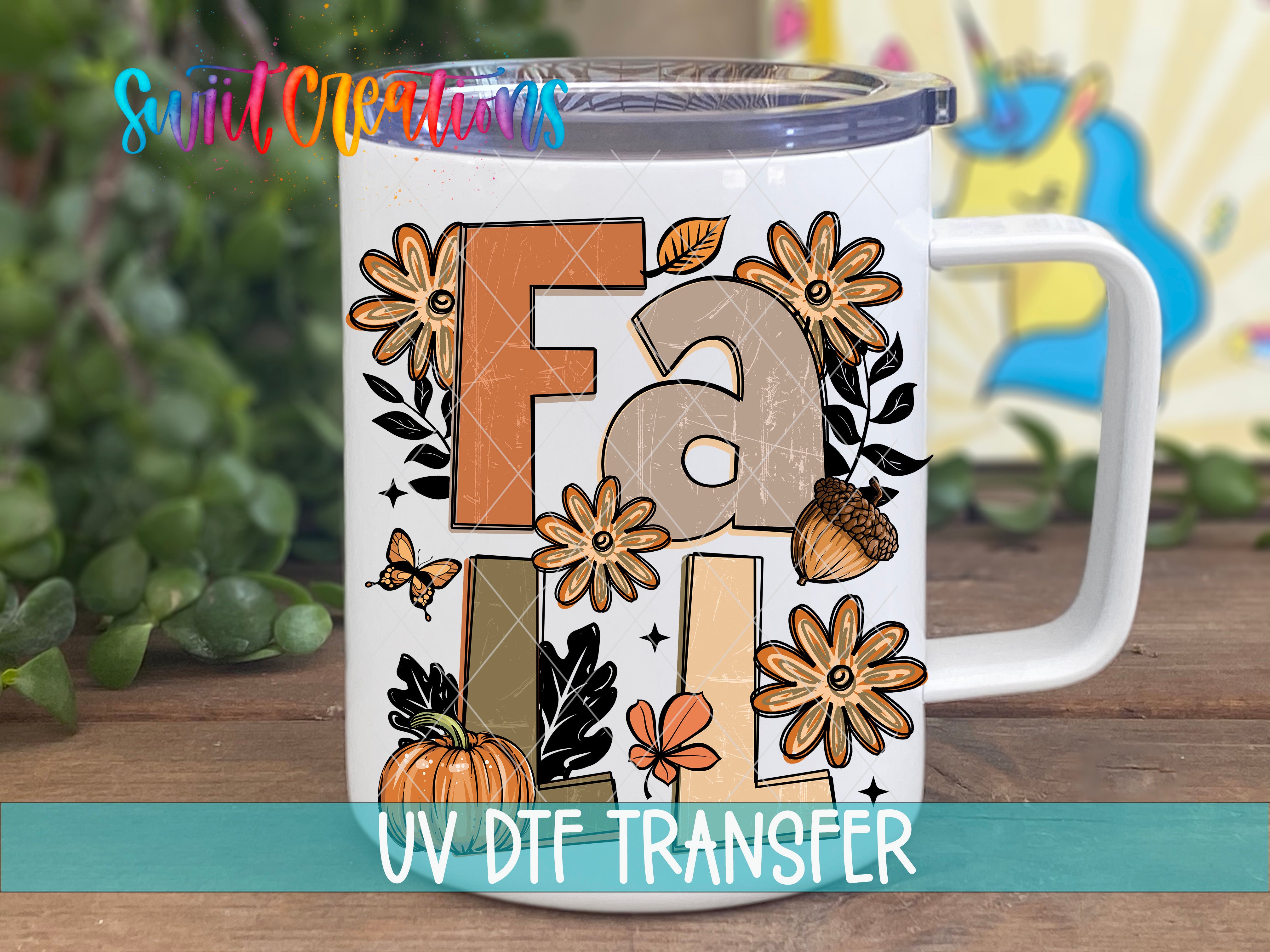 A white mug with a colorful autumn-themed design featuring the word "Fall" surrounded by various fall-themed elements such as flowers, leaves, and a pumpkin.