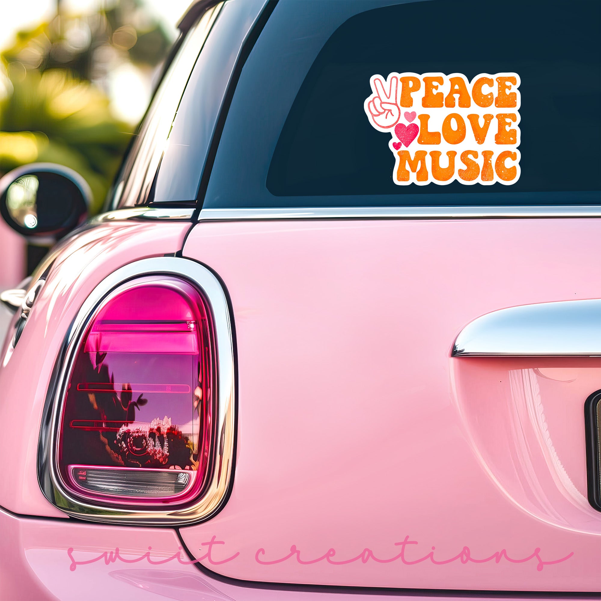 a pink car with a peace love music sticker on it