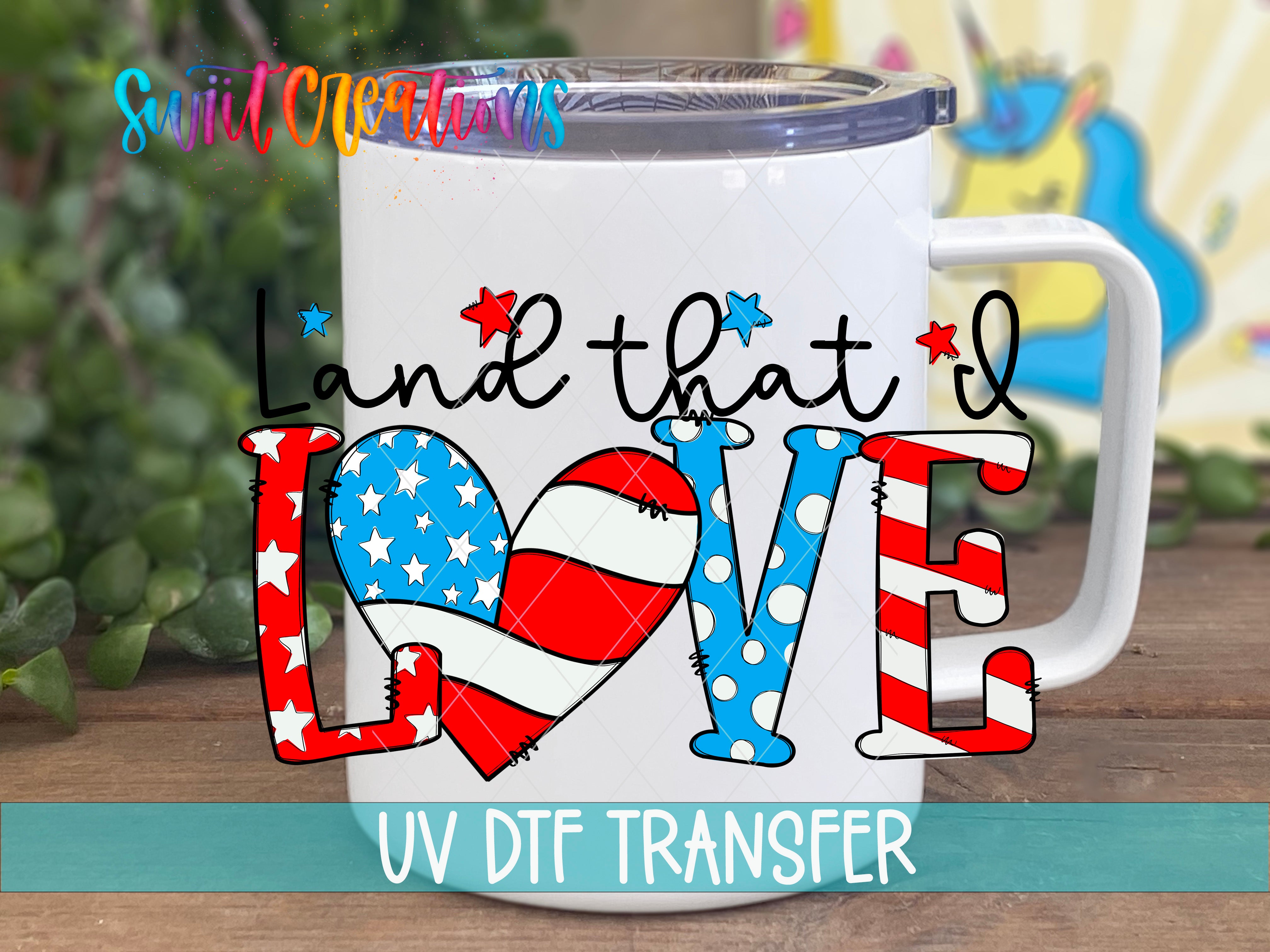 A white mug with a colorful design featuring the text "Land that I Love" and an American flag pattern.
