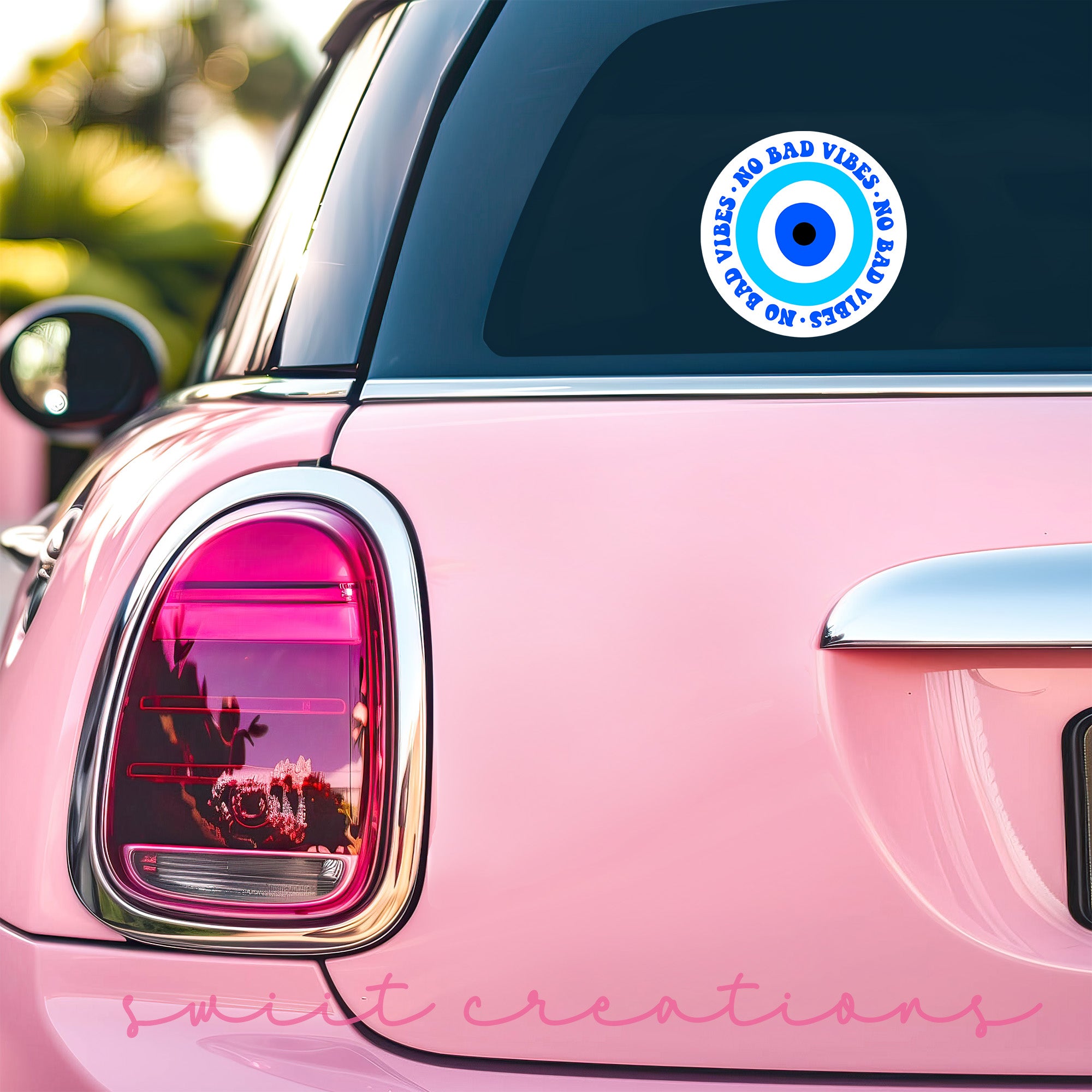 a pink car with a sticker on the back of it