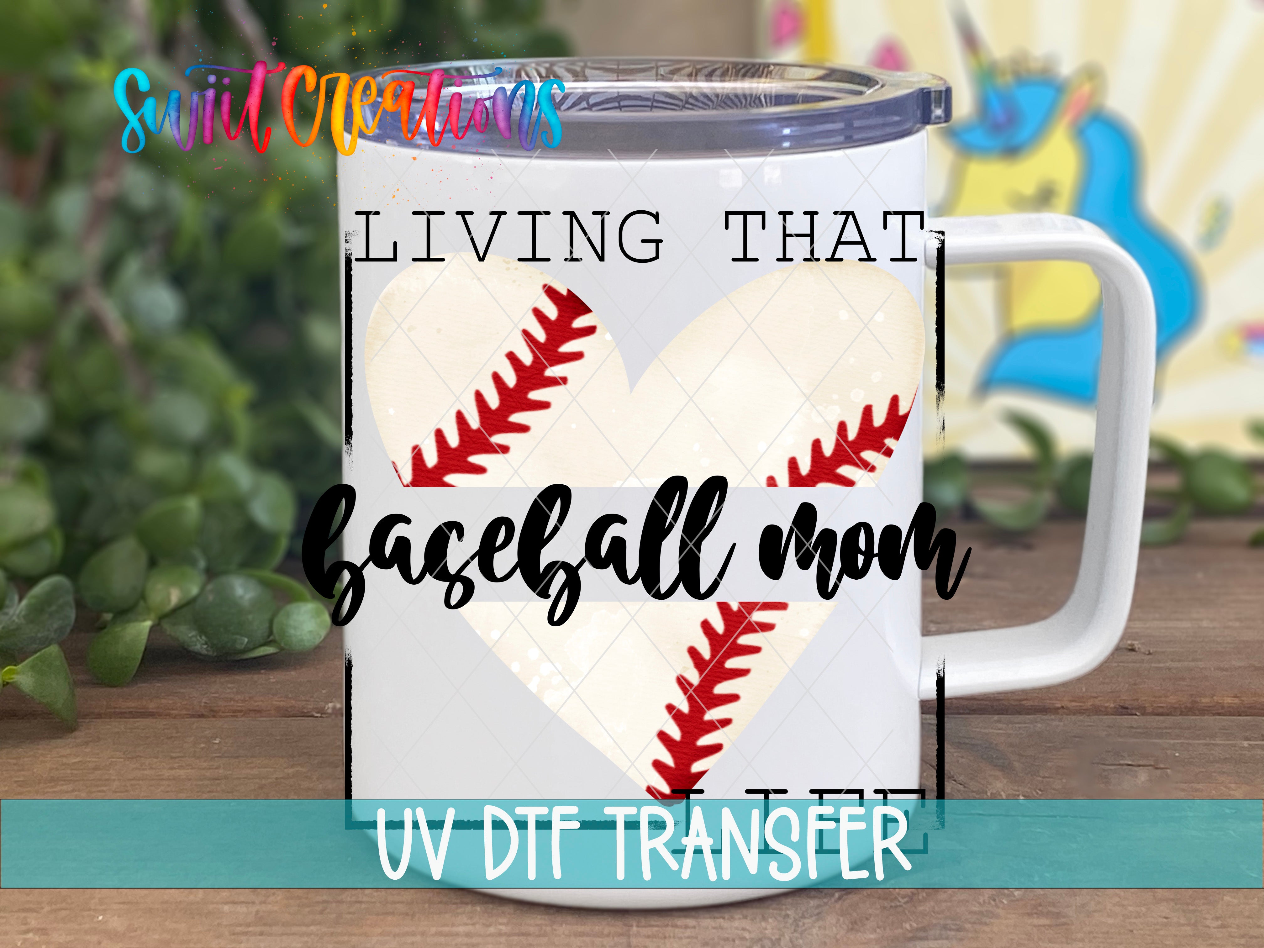 A white mug with a baseball design and text printed on it, placed on a wooden surface.