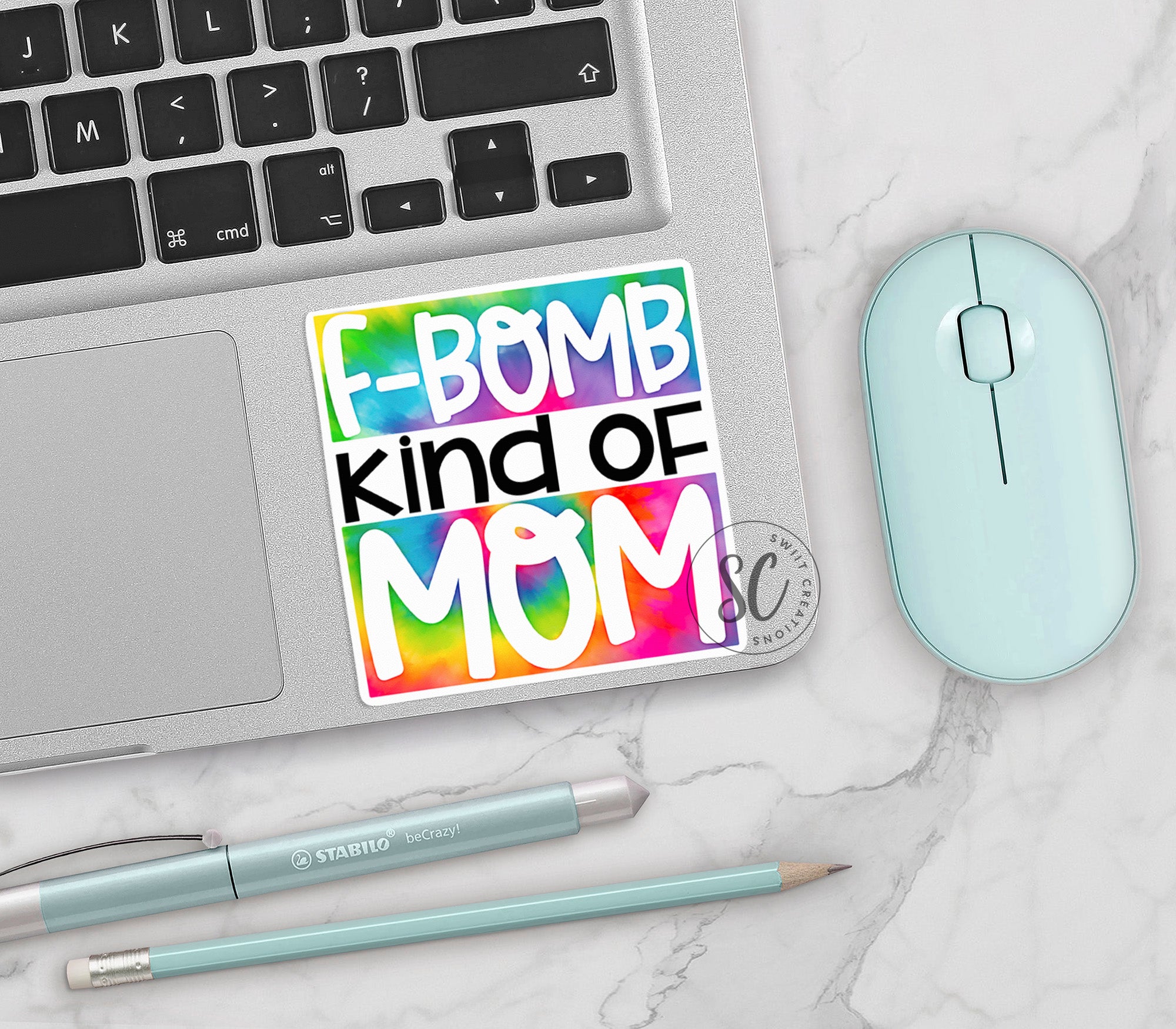 a keyboard, mouse, and sticker on a table