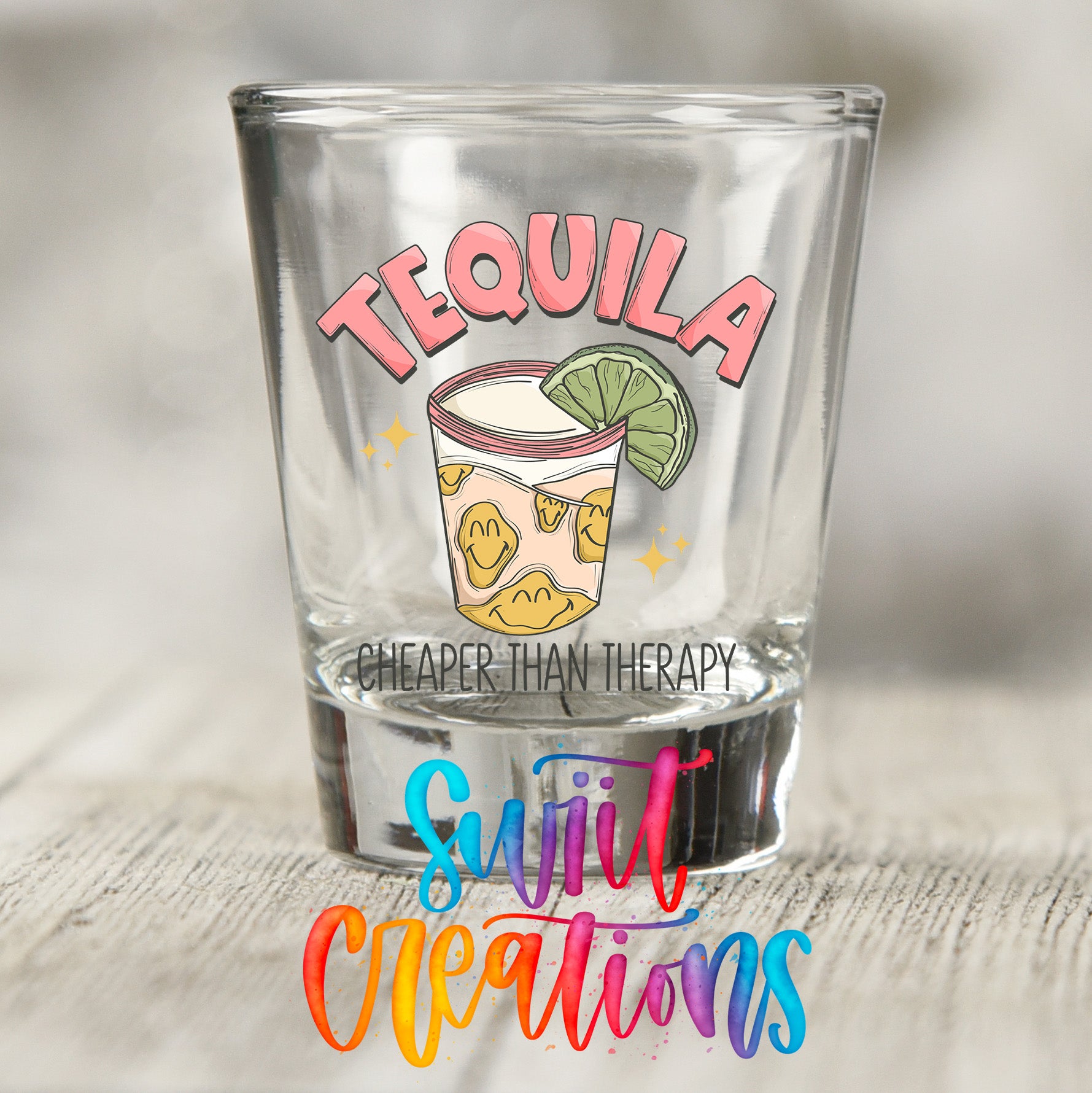 A shot glass with a tequila graphic and the text "Cheaper than therapy" printed on it.