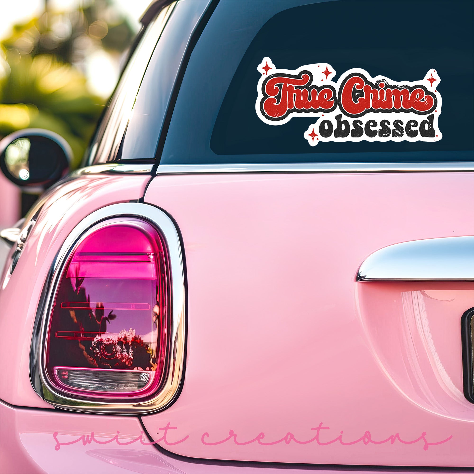 a pink car that has a sticker on it