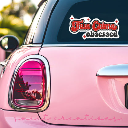 a pink car that has a sticker on it