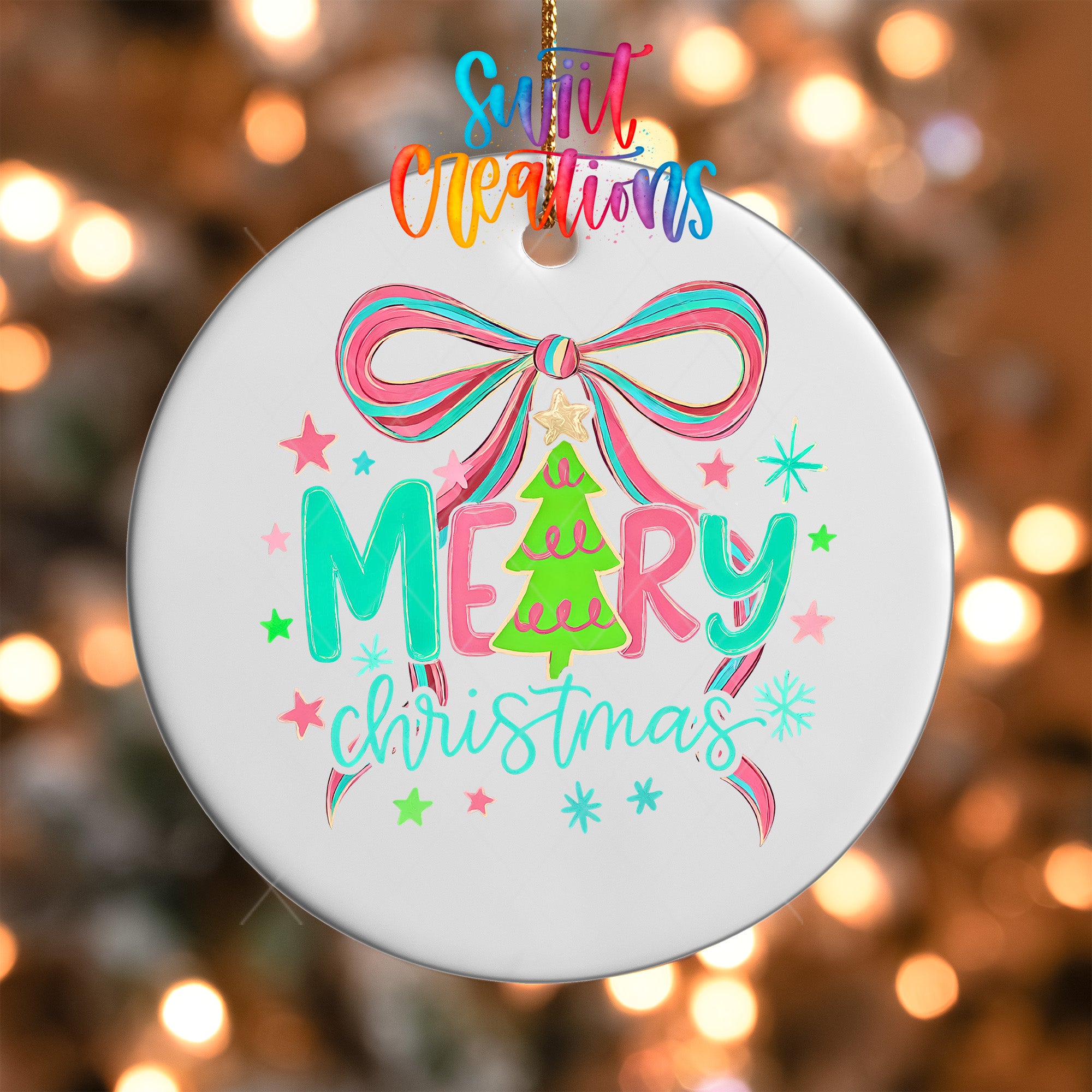 A white ornament with a colorful design featuring a bow, stars, and the text "Merry Christmas" hanging on a string.