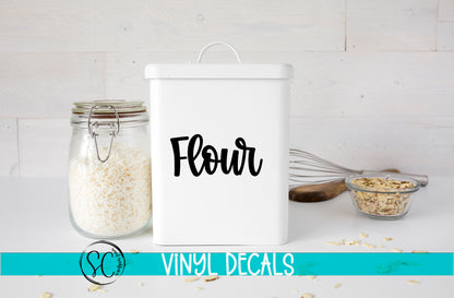 a white canister with the word flour next to it