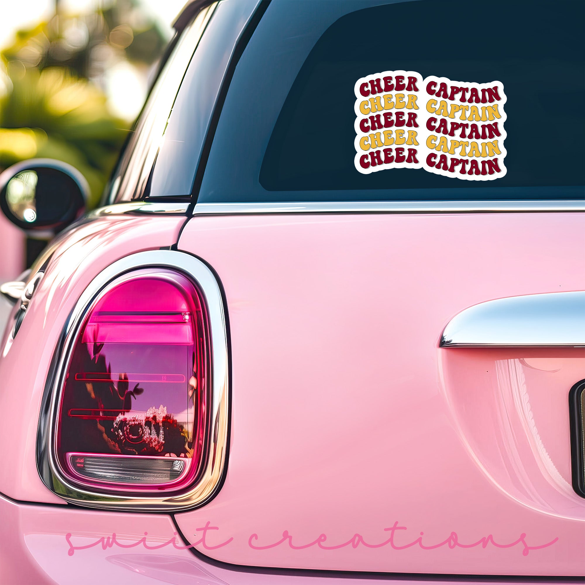 a pink car with a sticker on the back of it