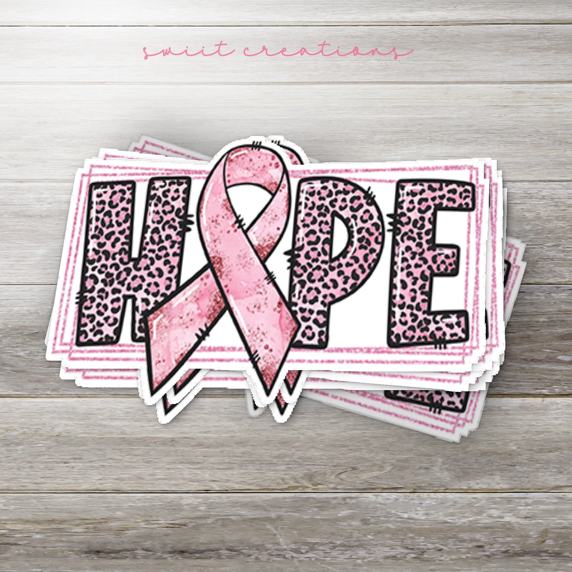 a sticker with a pink ribbon on it
