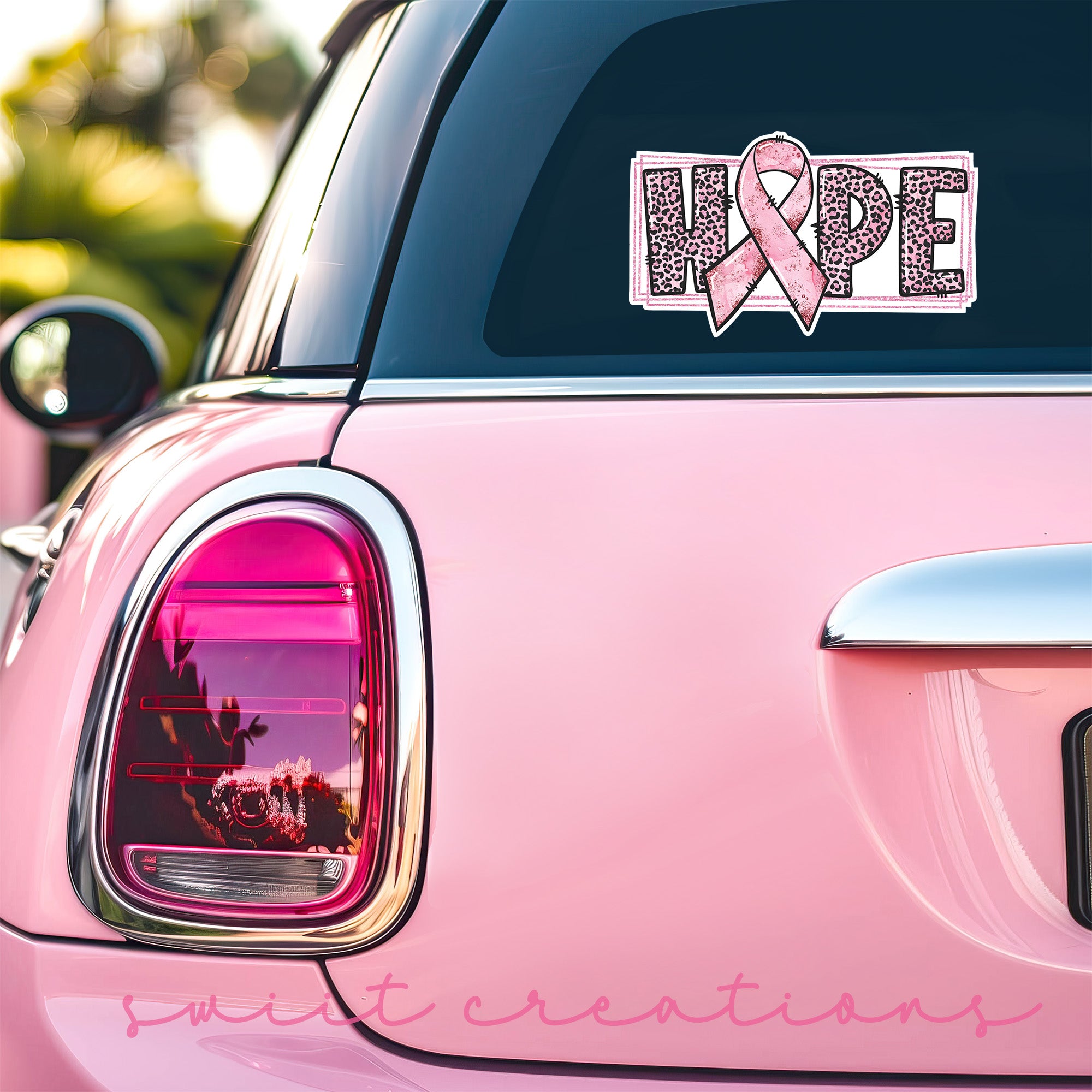 a pink car with a pink ribbon on it