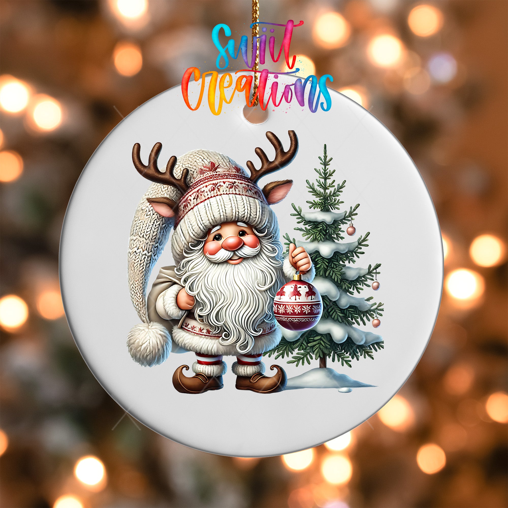 A white ornament featuring a Santa Claus figure with antlers and a Christmas tree, with the text "Sweet Creations" above the ornament.