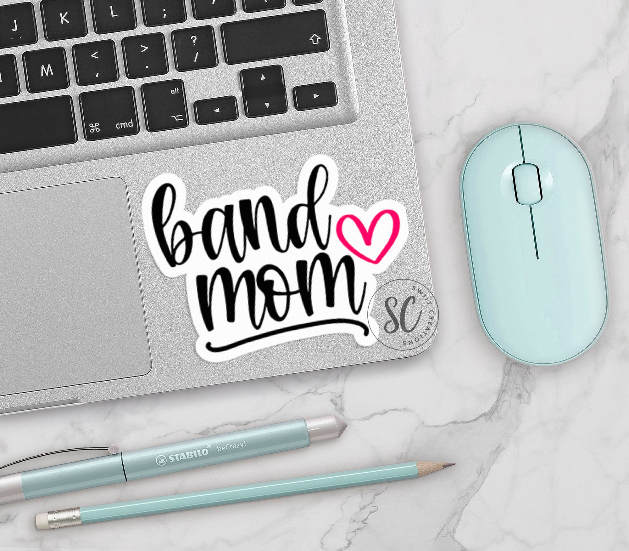 a laptop with a sticker that says band mom