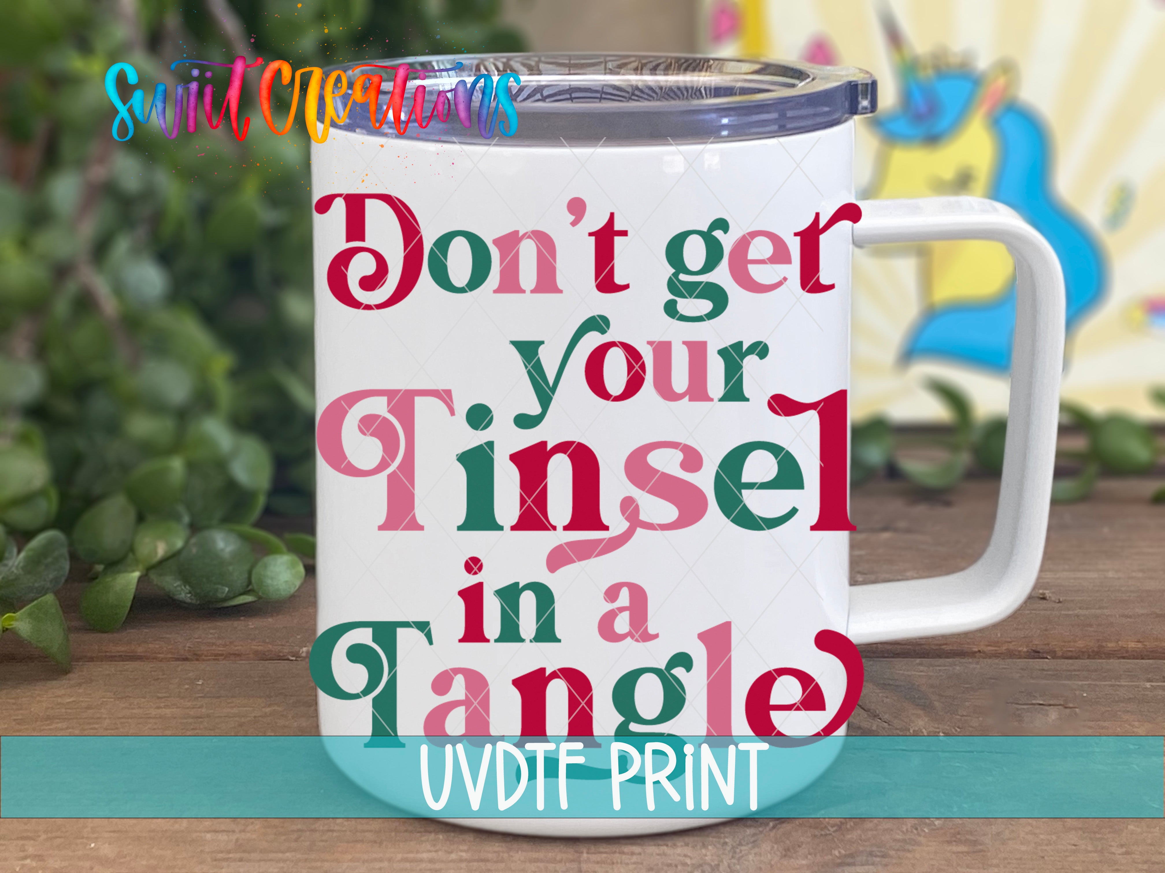 A white mug with colorful text printed on it, placed on a wooden surface.