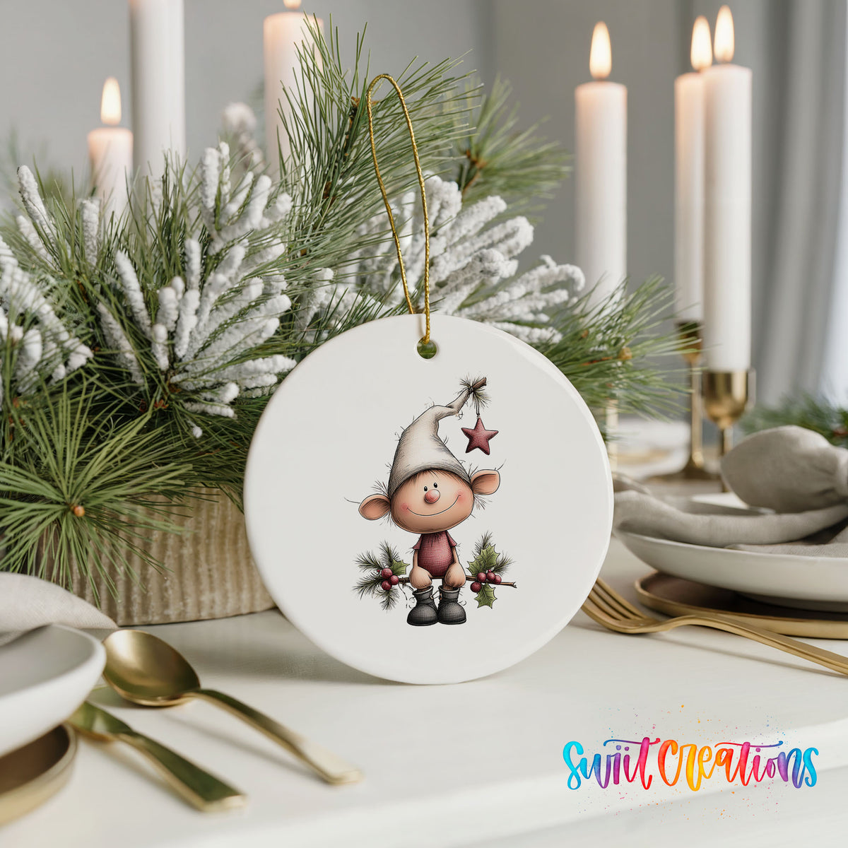 A white ceramic ornament featuring a cartoon elf is displayed on a table, surrounded by a festive arrangement of pine branches and candles.