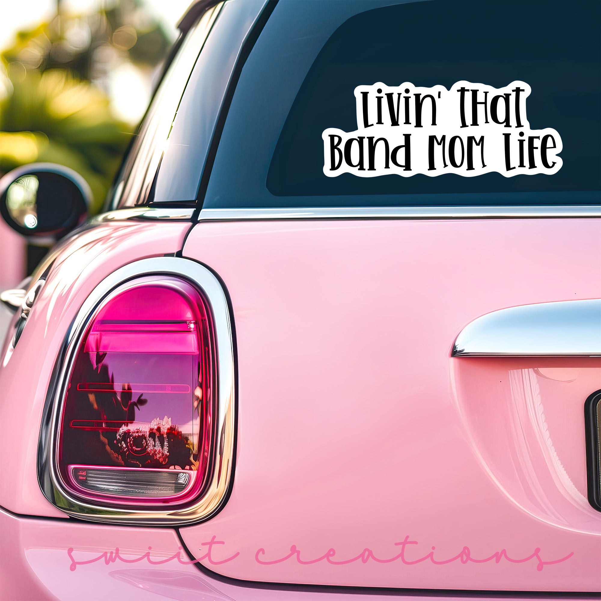 a pink car that has a sticker on it