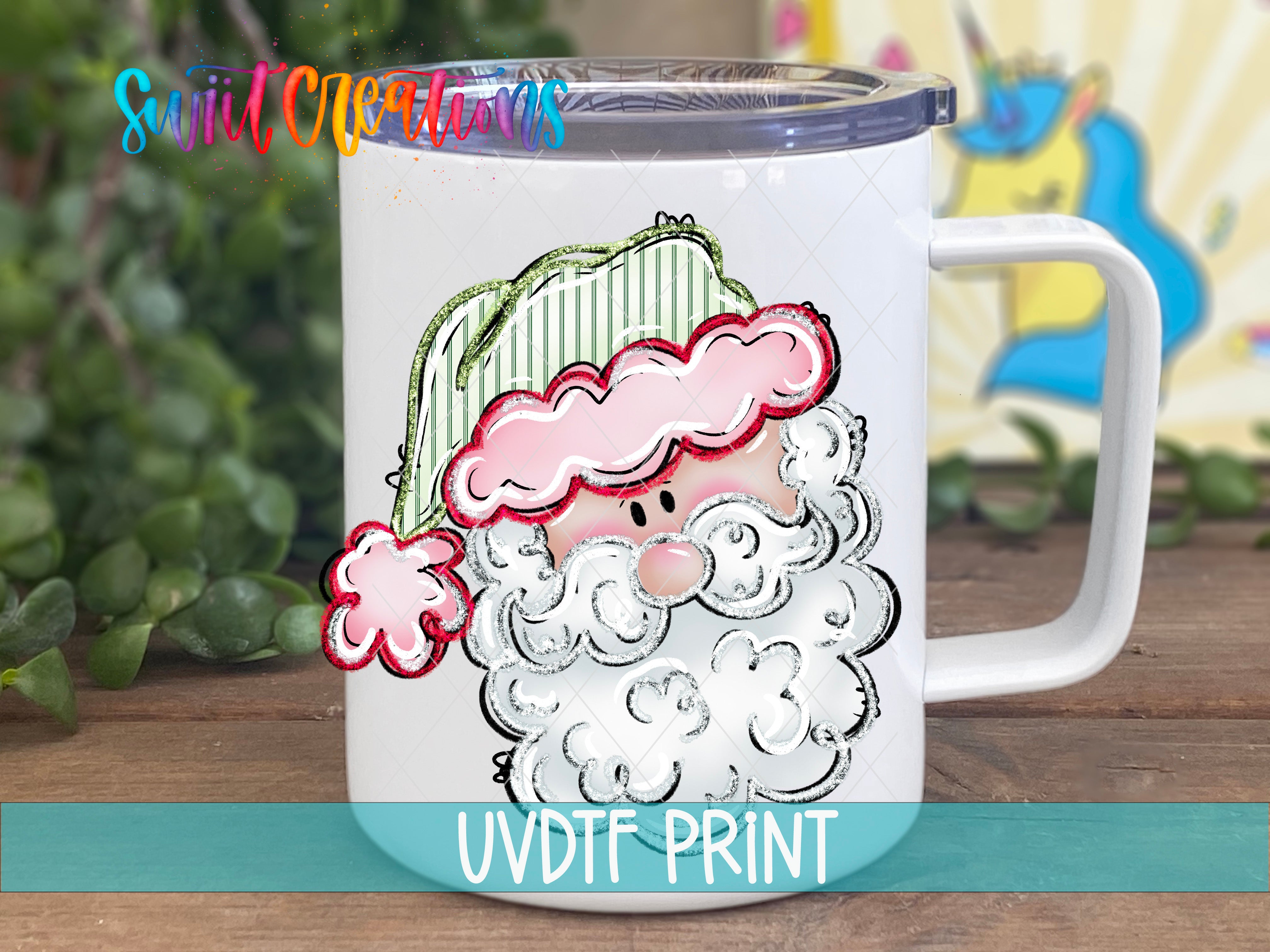 A white mug with a colorful illustration of a smiling Santa Claus on it, placed on a wooden surface.