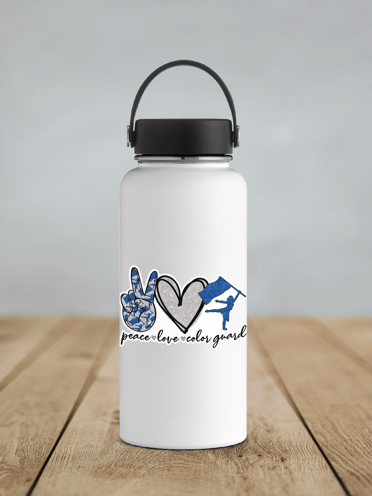 a white water bottle with a black lid on a wooden table