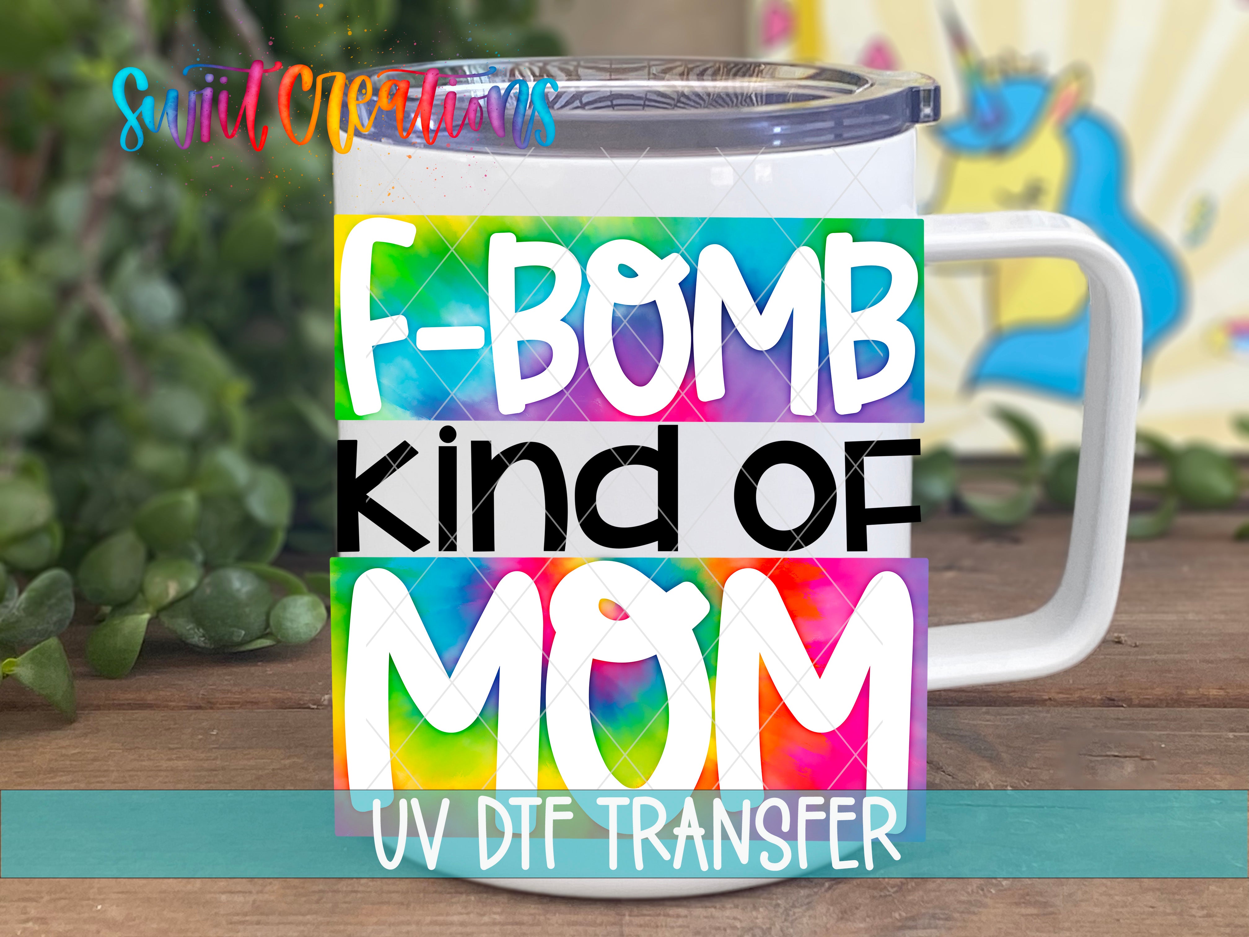 A white mug with a colorful design featuring the text "F-BOMB KIND OF MOM" and "UV Dtf Transfer" printed on it.