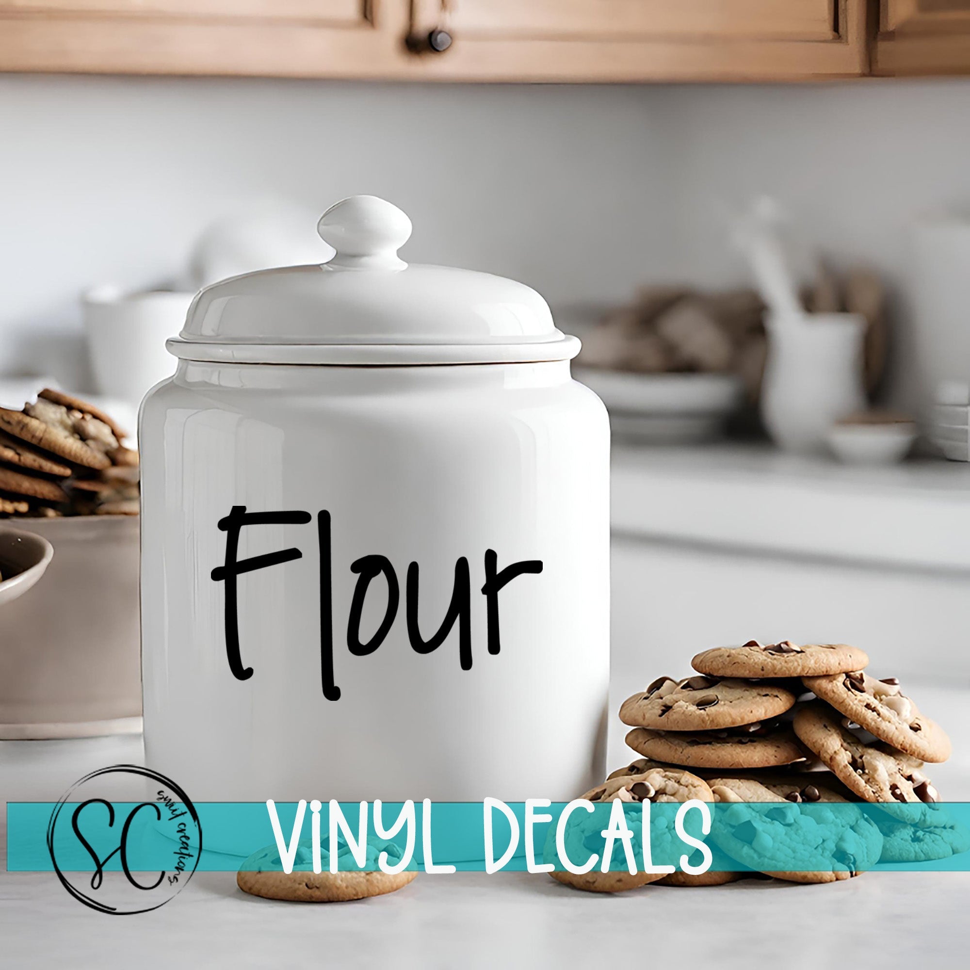 A white ceramic jar labeled "Flour" sits on a kitchen counter, with a stack of chocolate chip cookies nearby.
