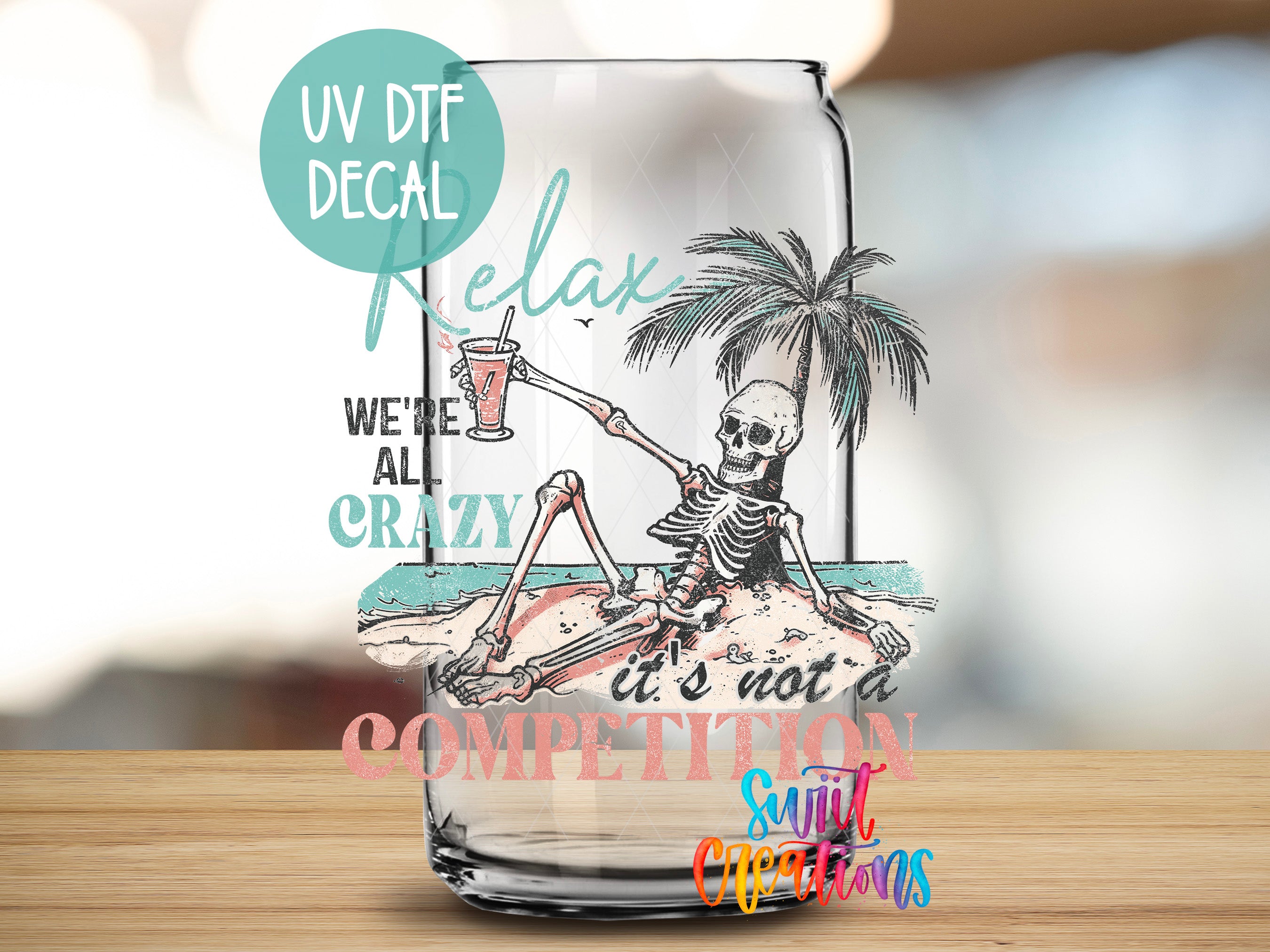 a glass with a skeleton sitting on a beach