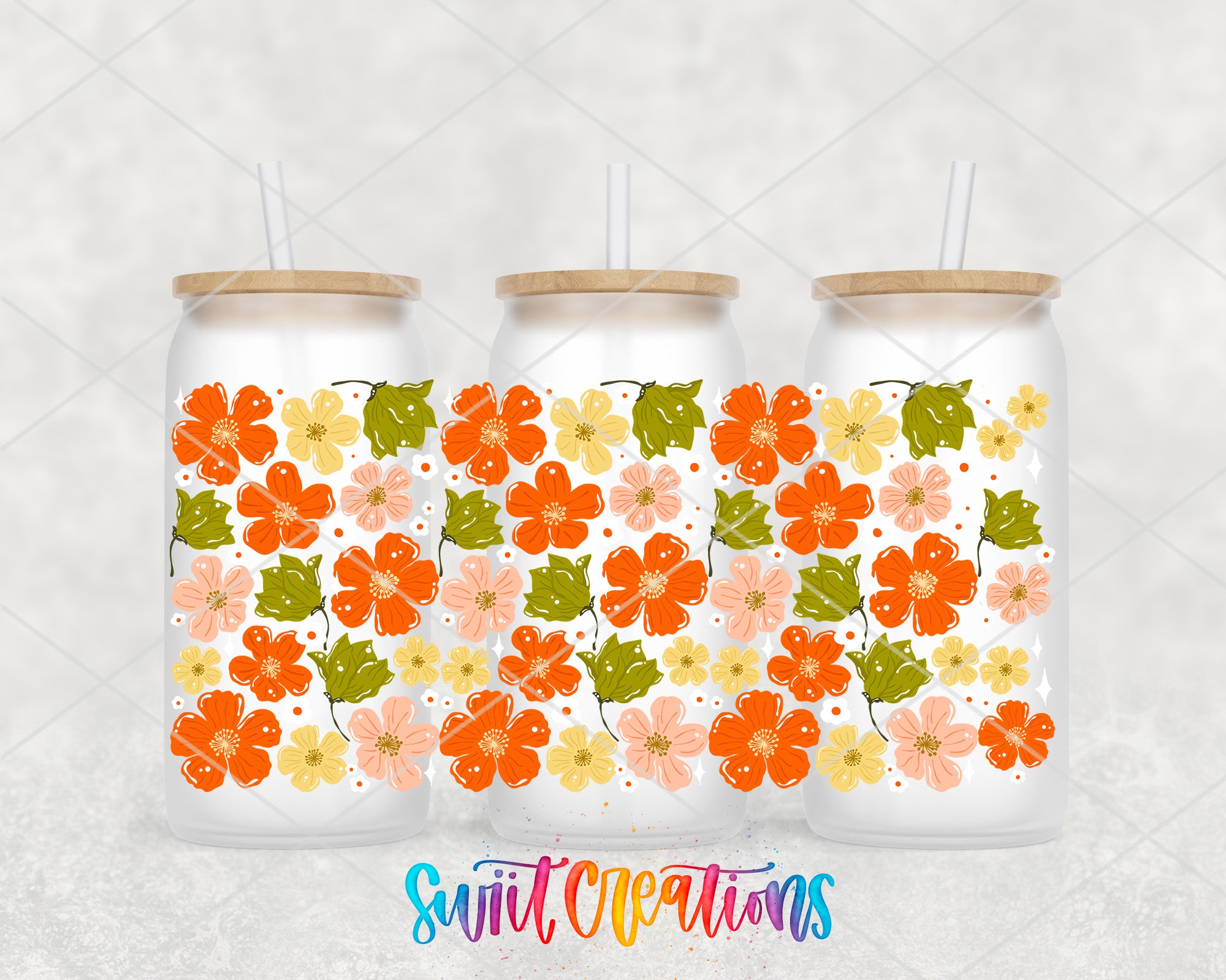 Three glass tumblers with floral designs on them, each with a straw.