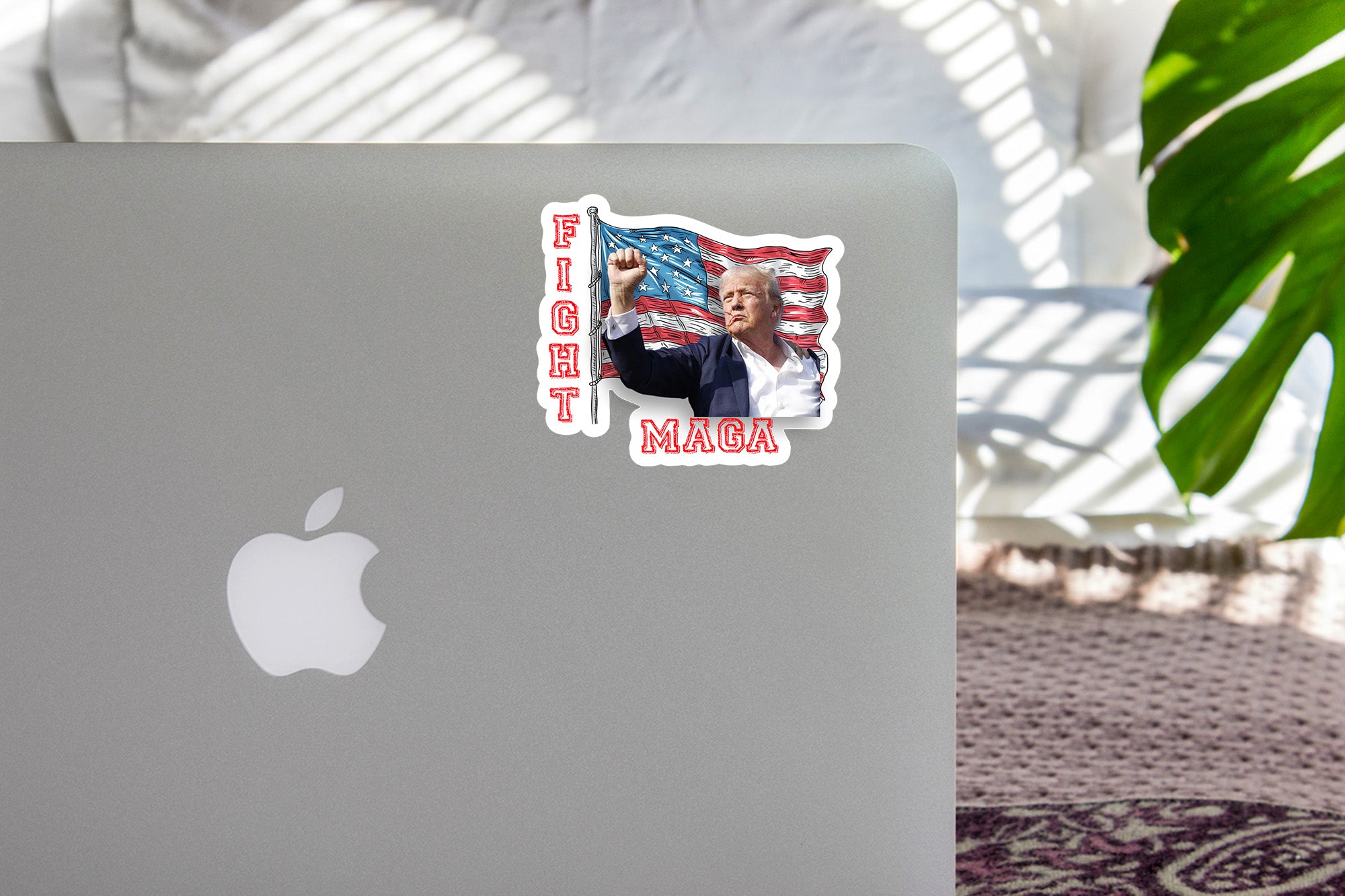 a laptop with a sticker of a man holding an american flag