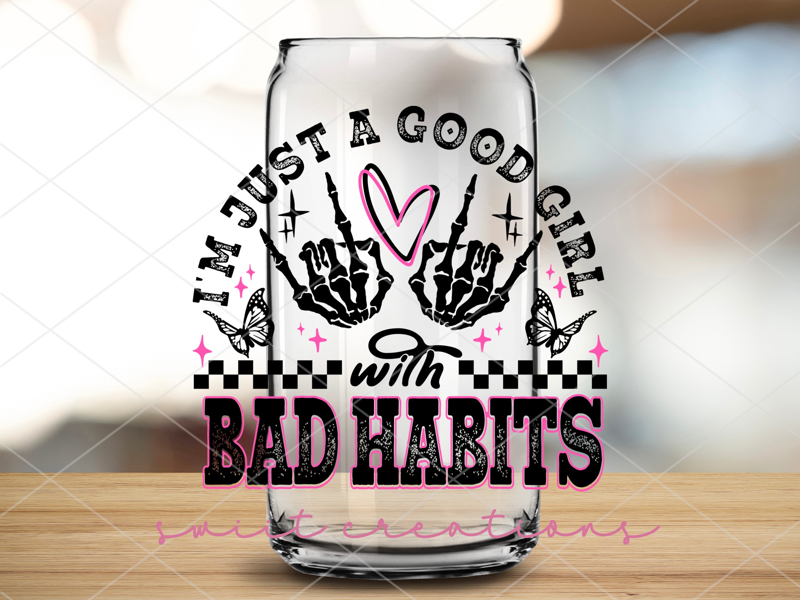 a glass with the words just a goodie and a picture of a pair of