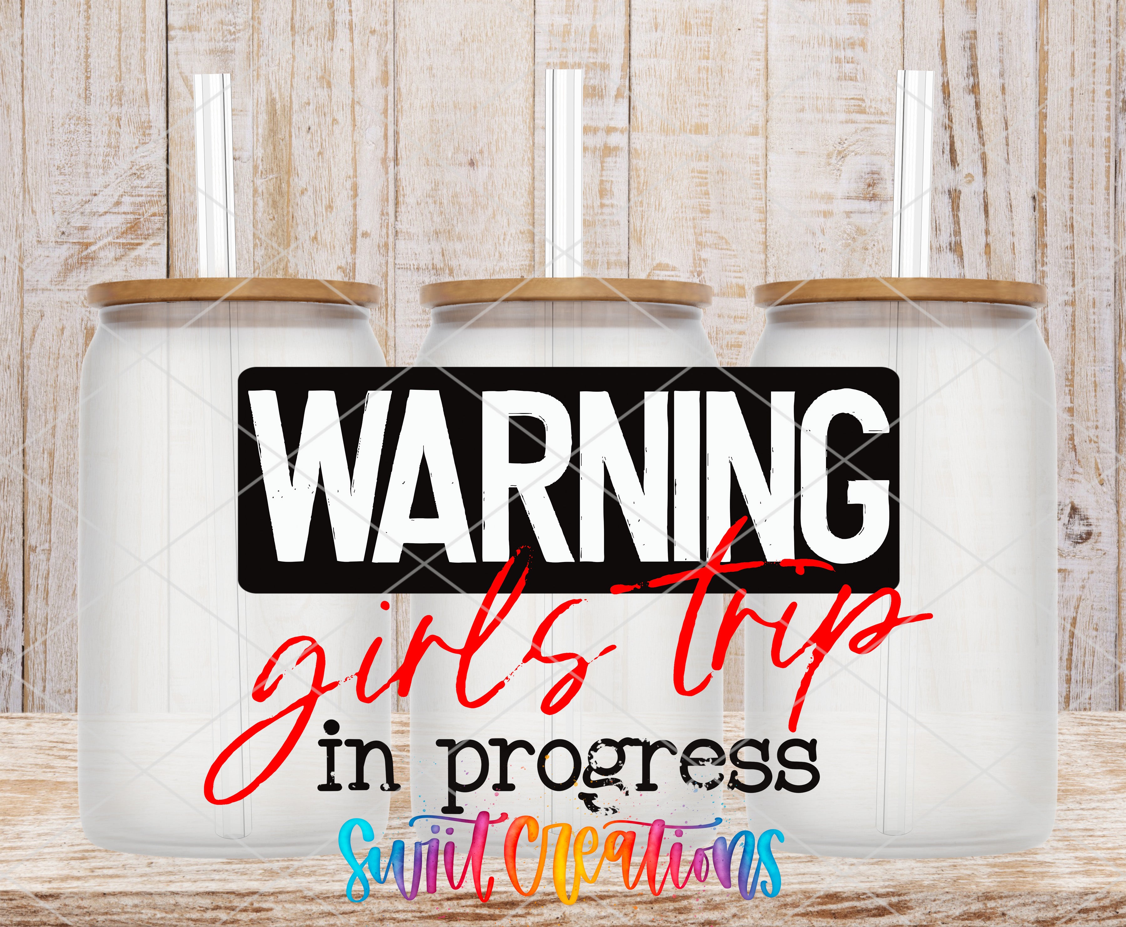 three clear glass jars with lids, each containing a straw, arranged in a row against a wooden background. The text "WARNING girls trip in progress" is displayed prominently in the center of the image.