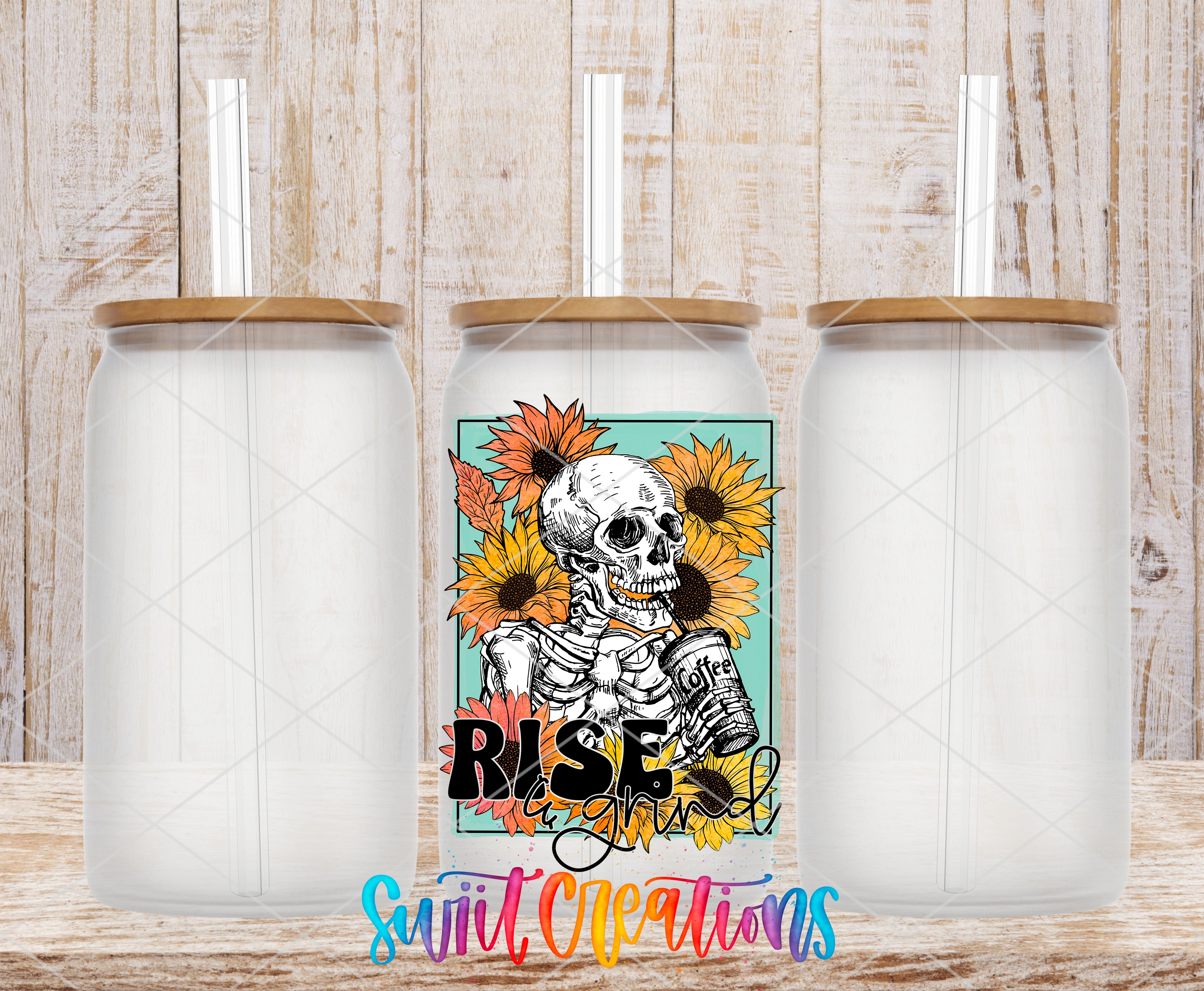 three clear glass jars with lids, each containing a straw. The jars are arranged in a row, with the middle jar having a colorful design featuring a skeleton and sunflowers. The phrase "Rise and Shine" is written below the design.