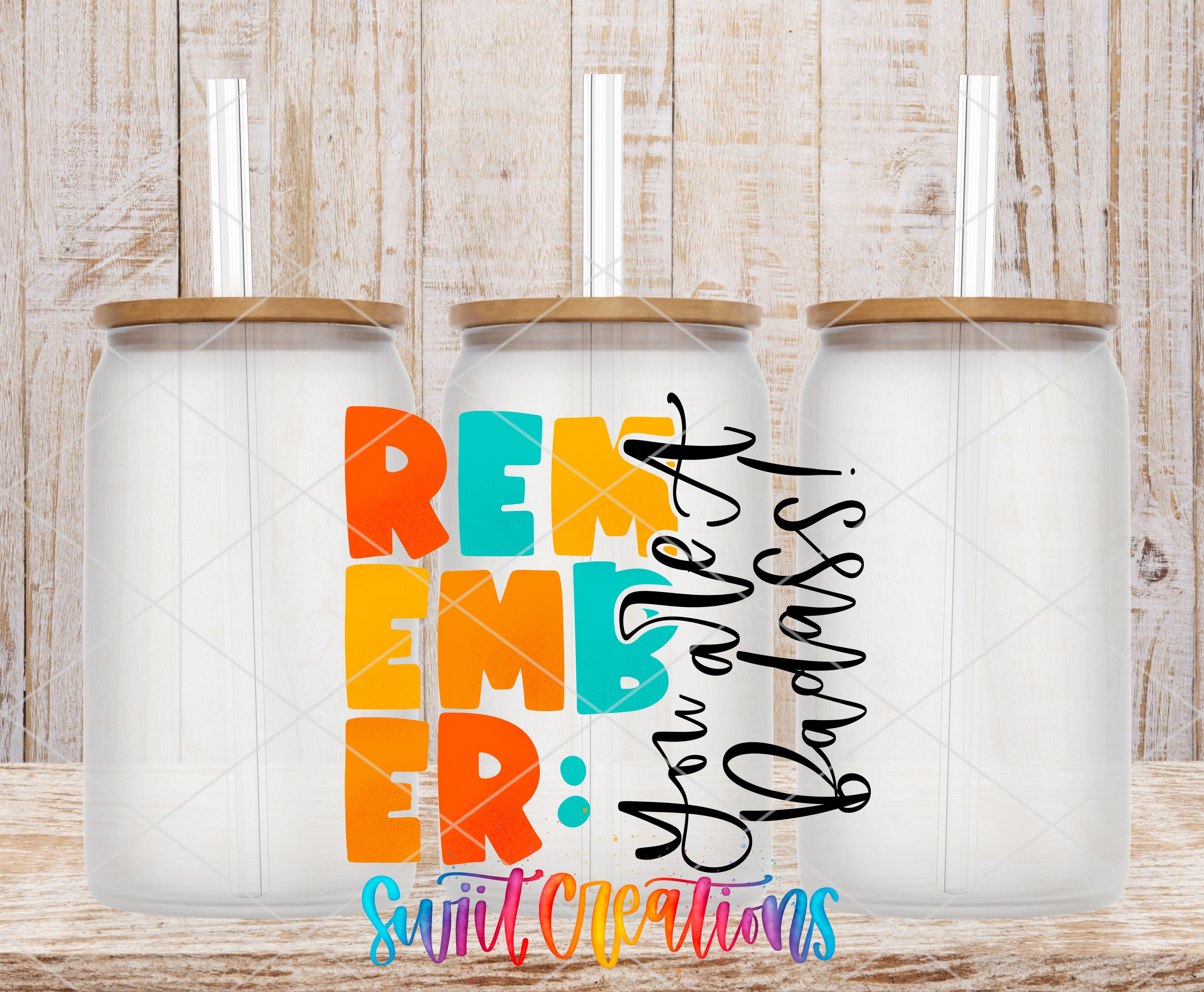 three glass jars with lids, arranged in a row against a wooden background. The jars have straws sticking out of them. The image also contains text that reads "Remember" and "Love", which are written in a colorful and stylized font.