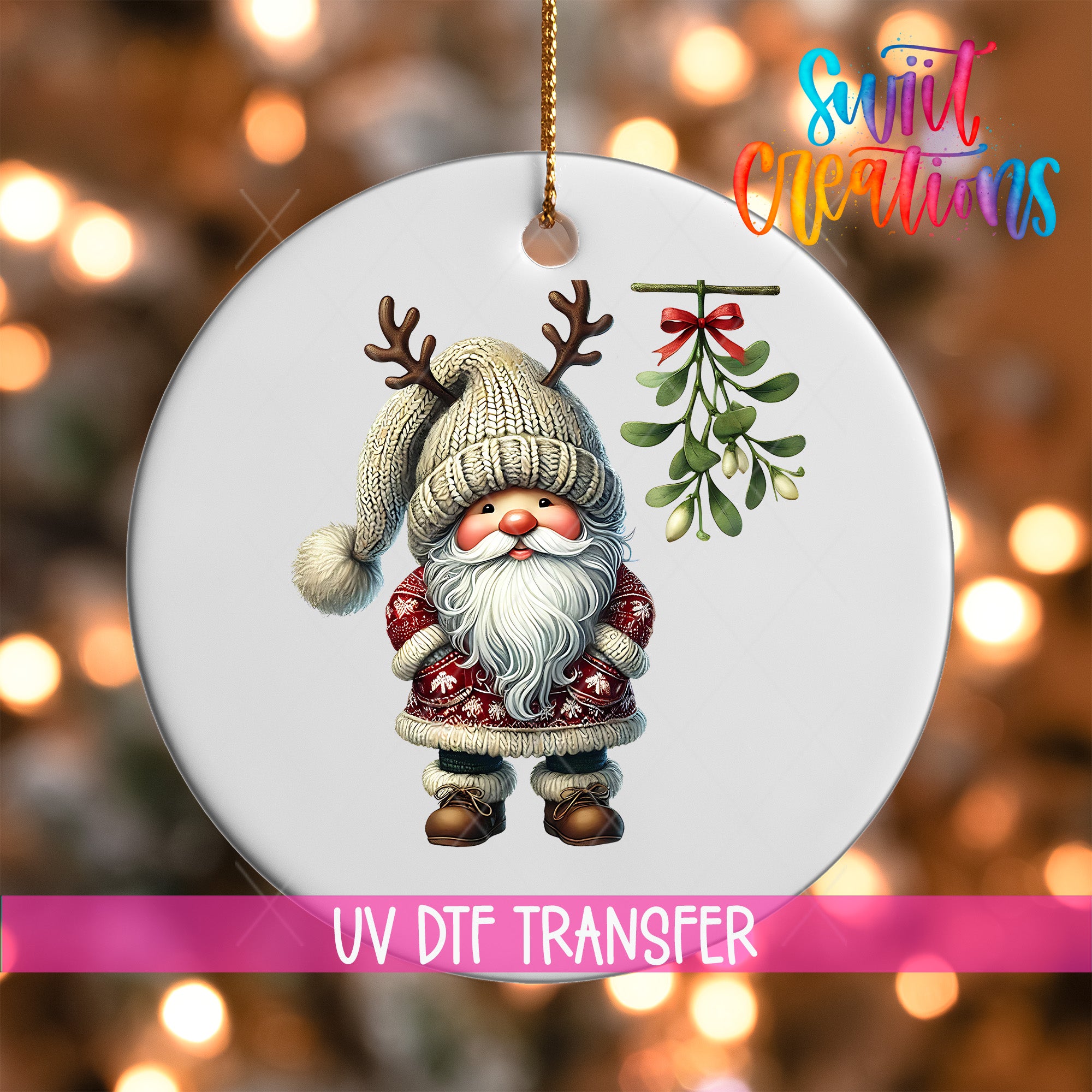 A white ornament featuring a Santa Claus figure with antlers and a mistletoe, with a pink ribbon below the ornament.