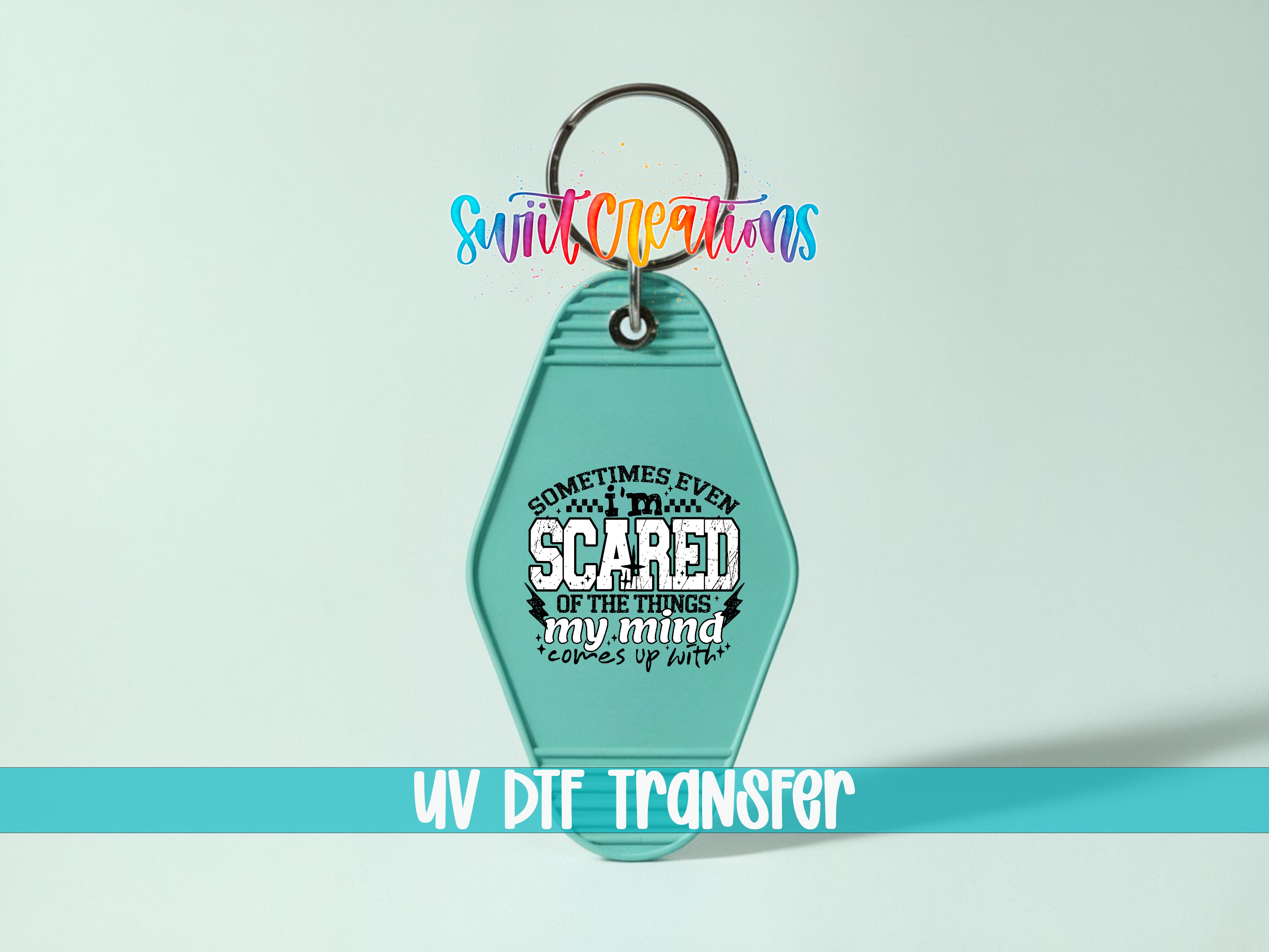 A keychain with a message printed on it, sitting on a light blue background.