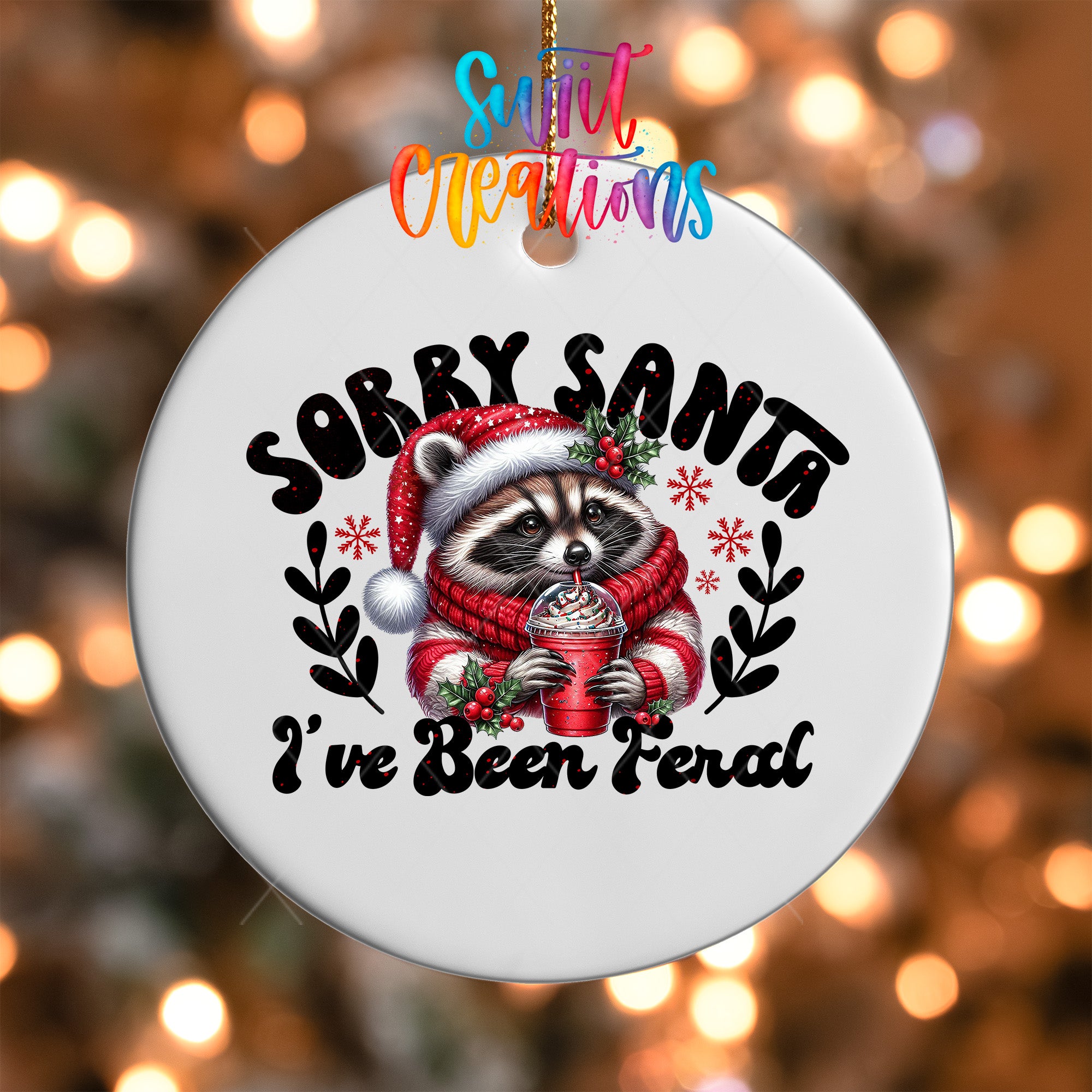 A white ornament with a raccoon wearing a Santa hat and scarf, holding a drink, and the text "Sorry Santa I've Been Ferald" printed on it.