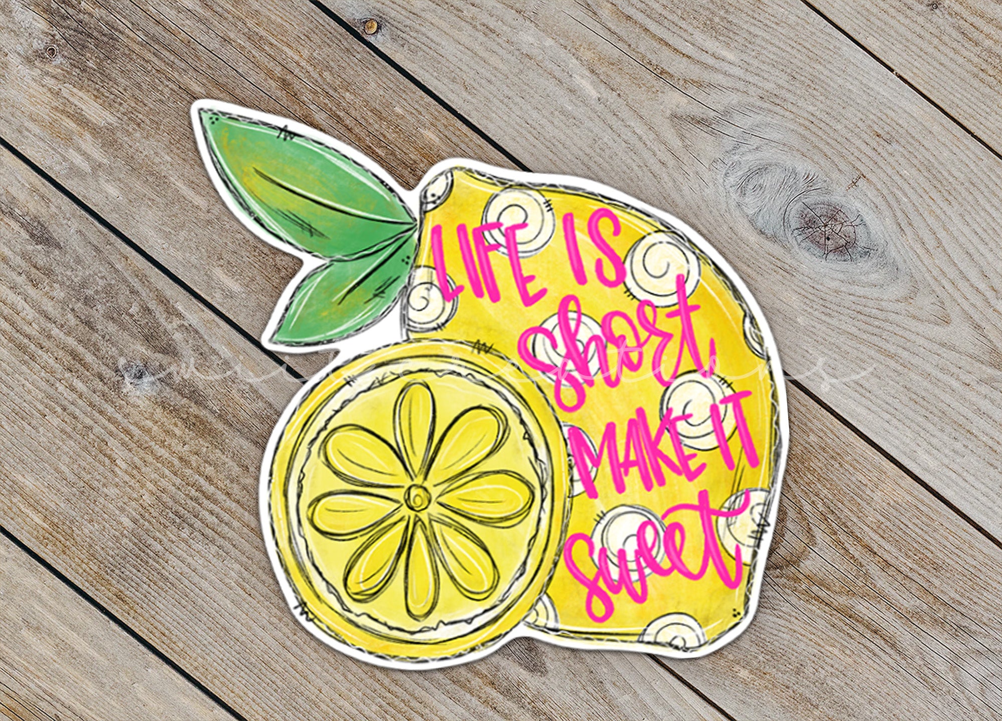 a sticker of a lemon on a wooden surface