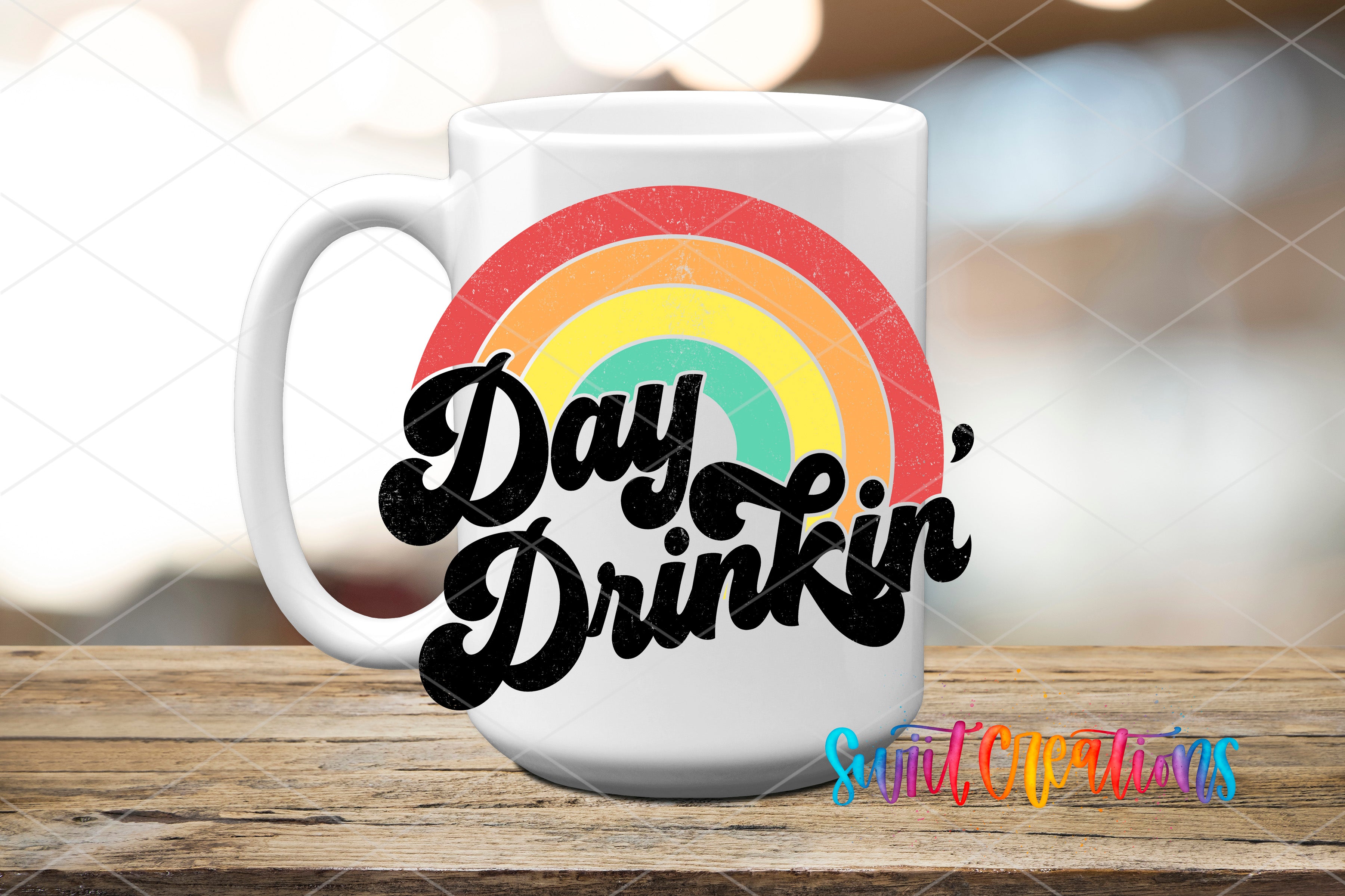 A white mug with a colorful rainbow design and the text "Day Drinker" printed on it.