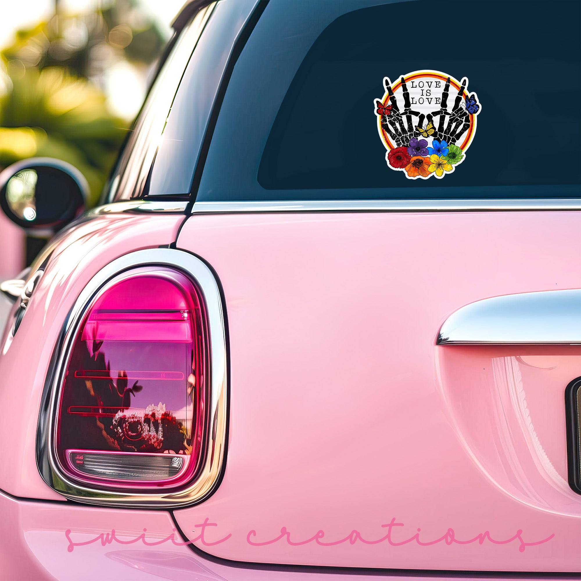 a pink car with a sticker on the back of it