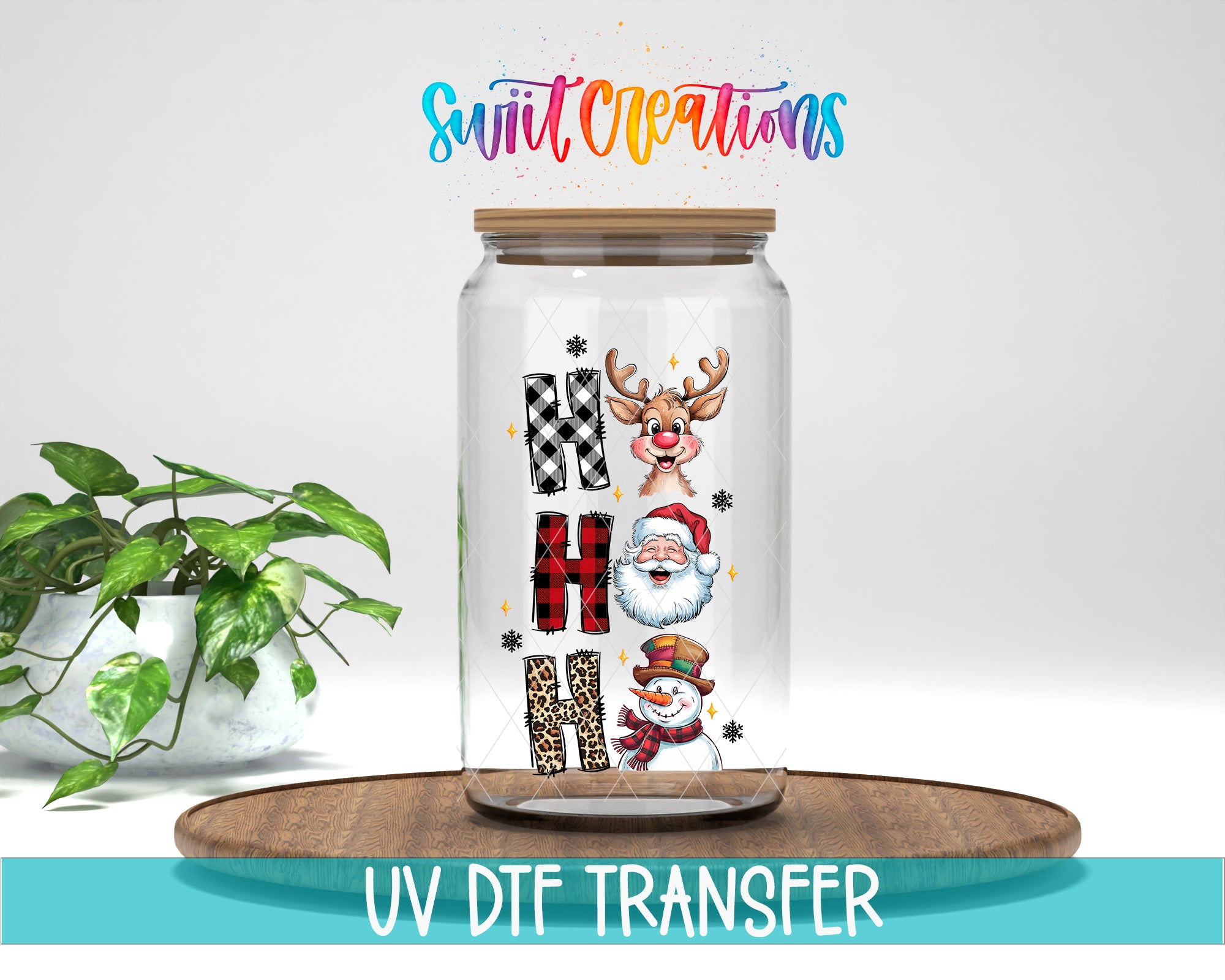 A glass jar with a lid, decorated with various Christmas-themed illustrations, including a reindeer, Santa Claus, and a snowman. The jar is placed on a wooden surface, and there is a potted plant in the background.