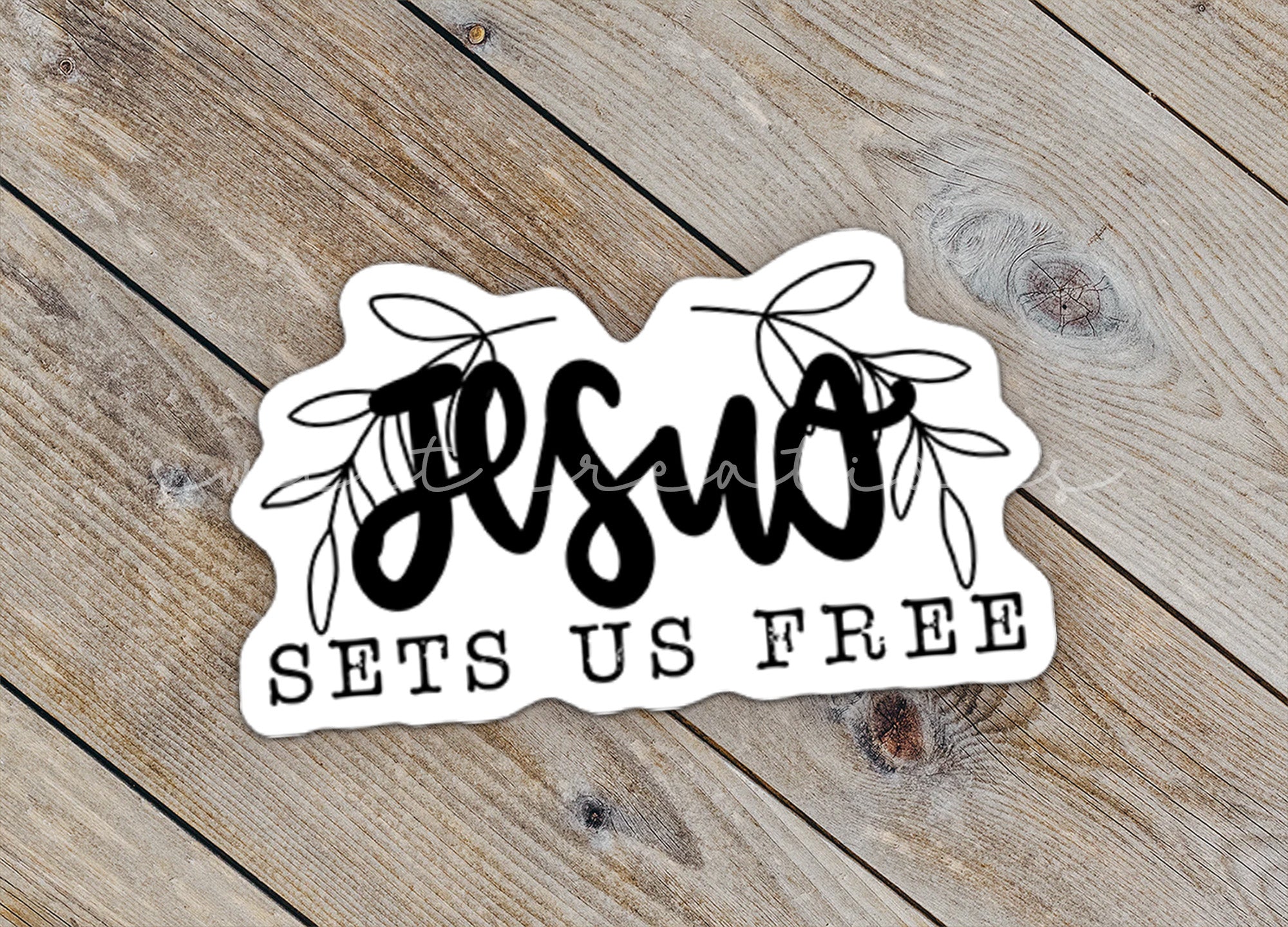 a sticker with the word bsu sits on a wooden surface