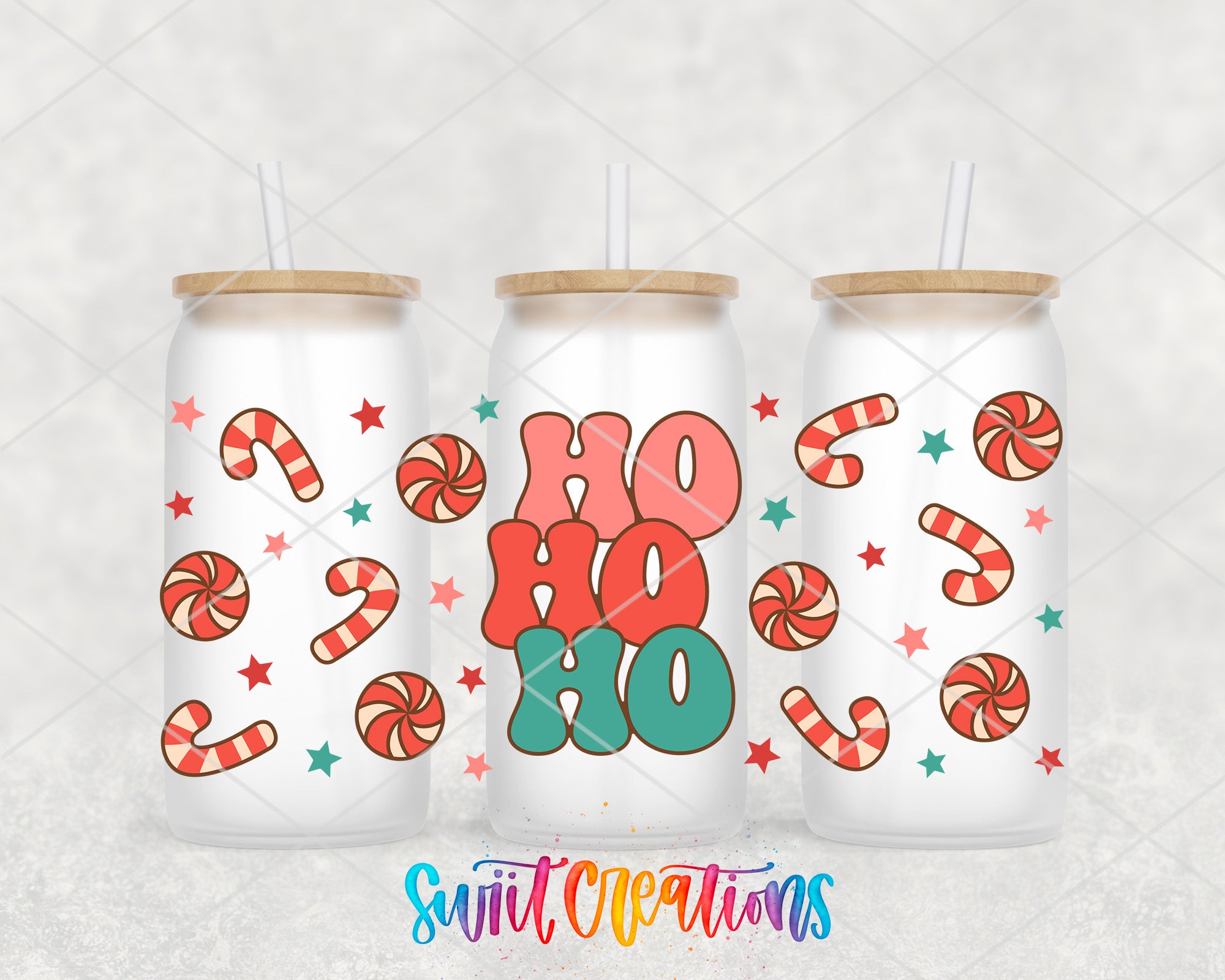 three white tumblers with colorful candy designs and the text "HO HO" printed on them.