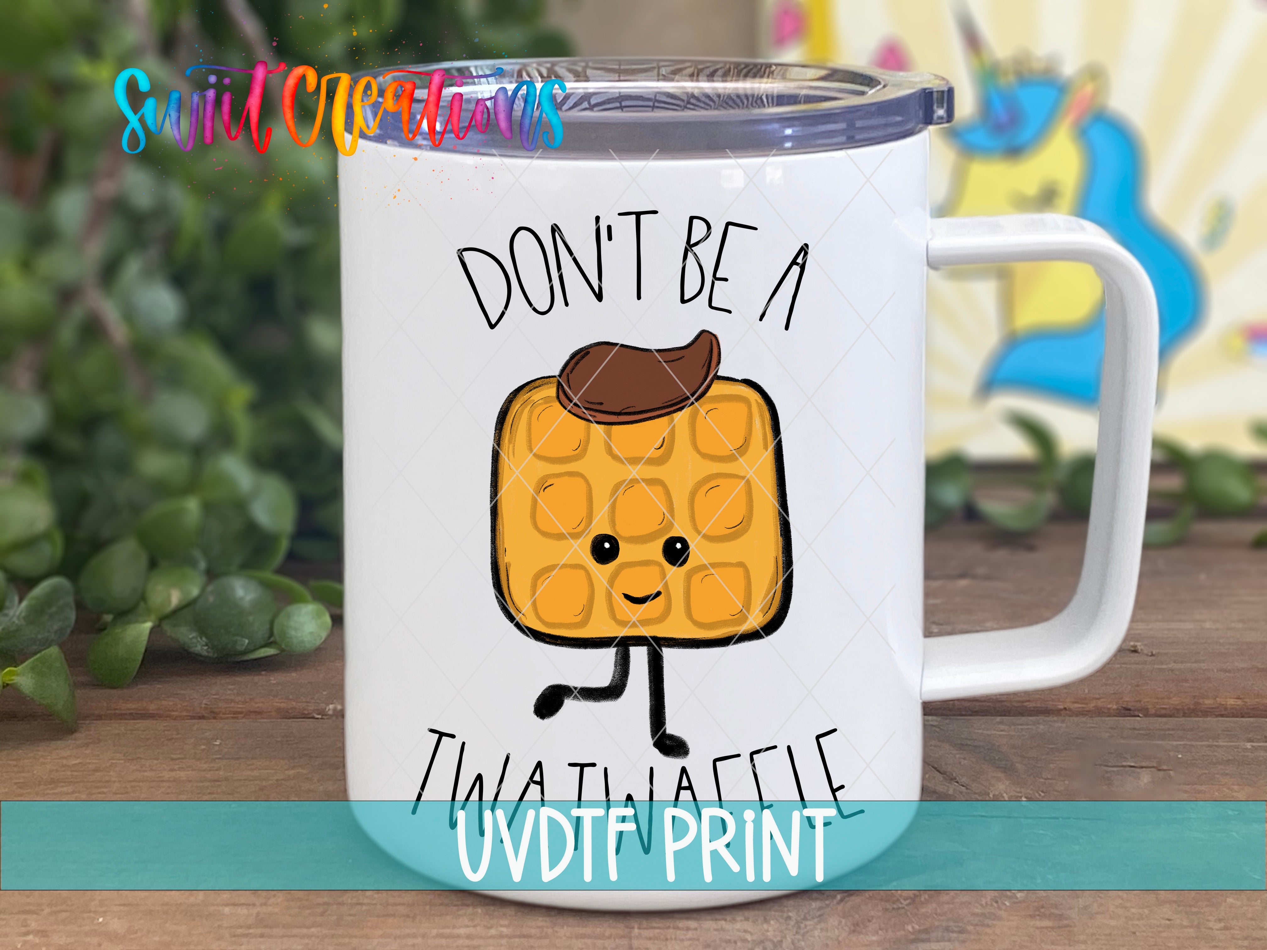 A white mug with a cartoon image of a waffle and the text "DON'T BE A TWATWAFLE" printed on it.